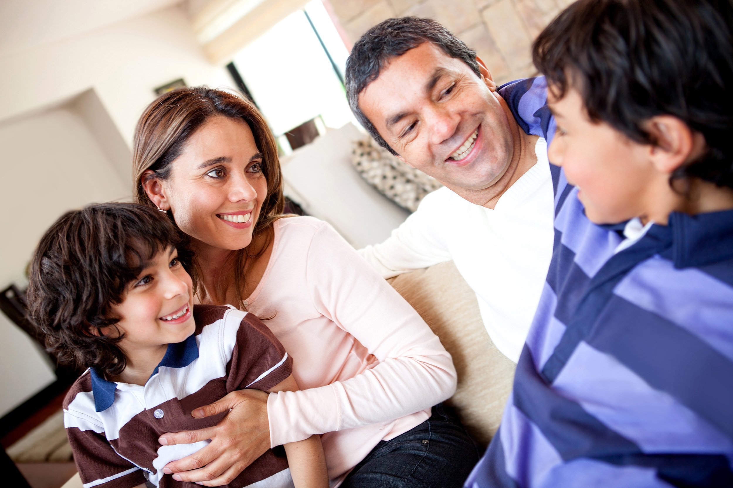 family talking on the couch and a boy telling a story
