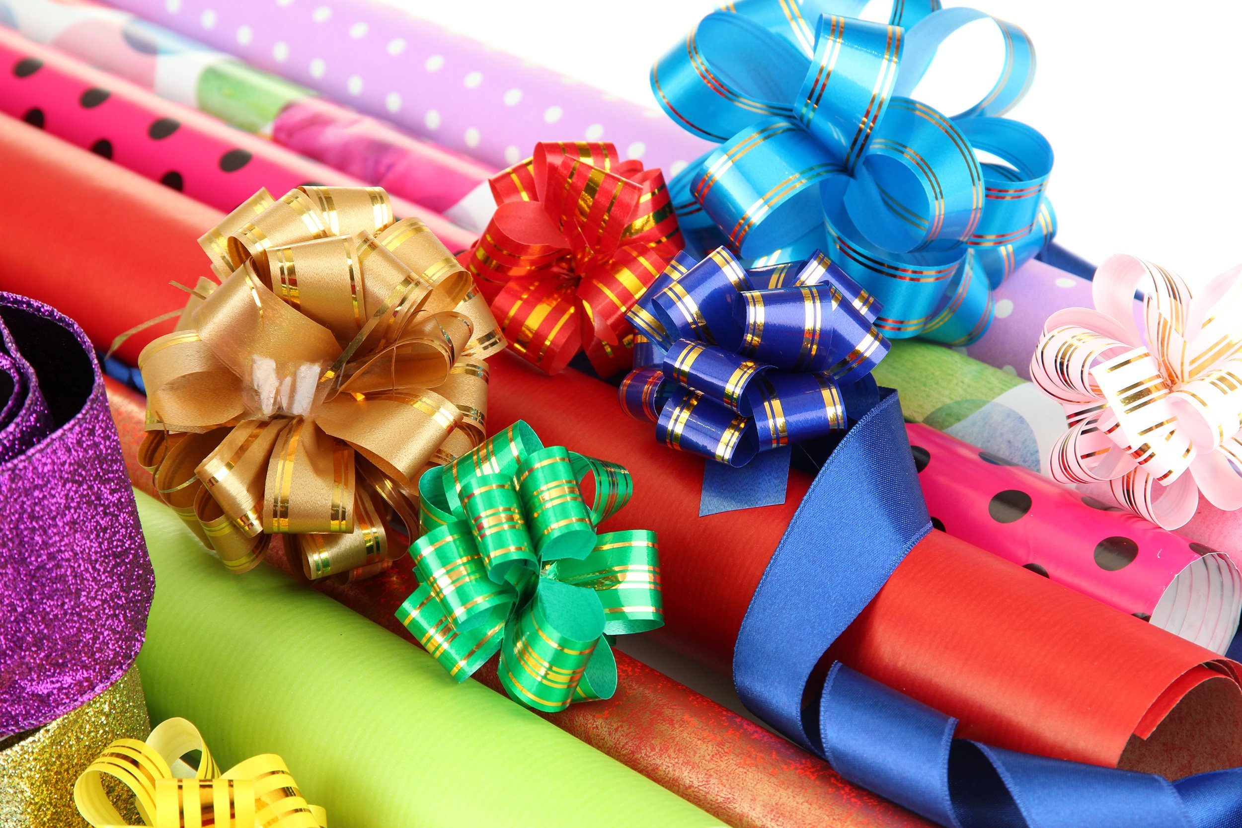 rolls of wrapping paper with ribbons and bows