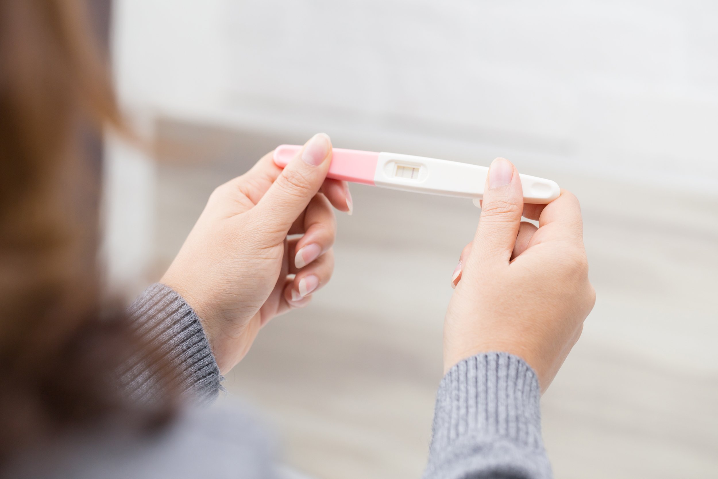 woman holding pregnancy test