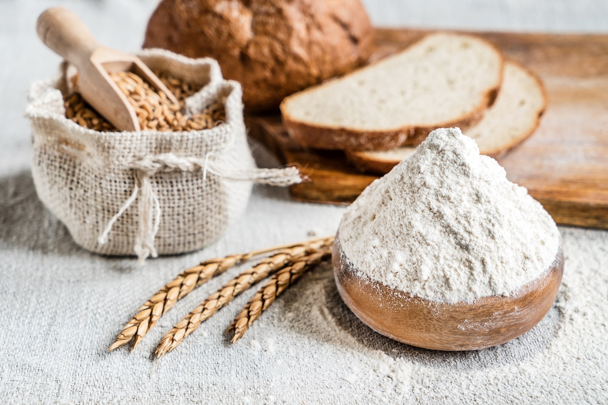 wheat, flour, and bread on the table