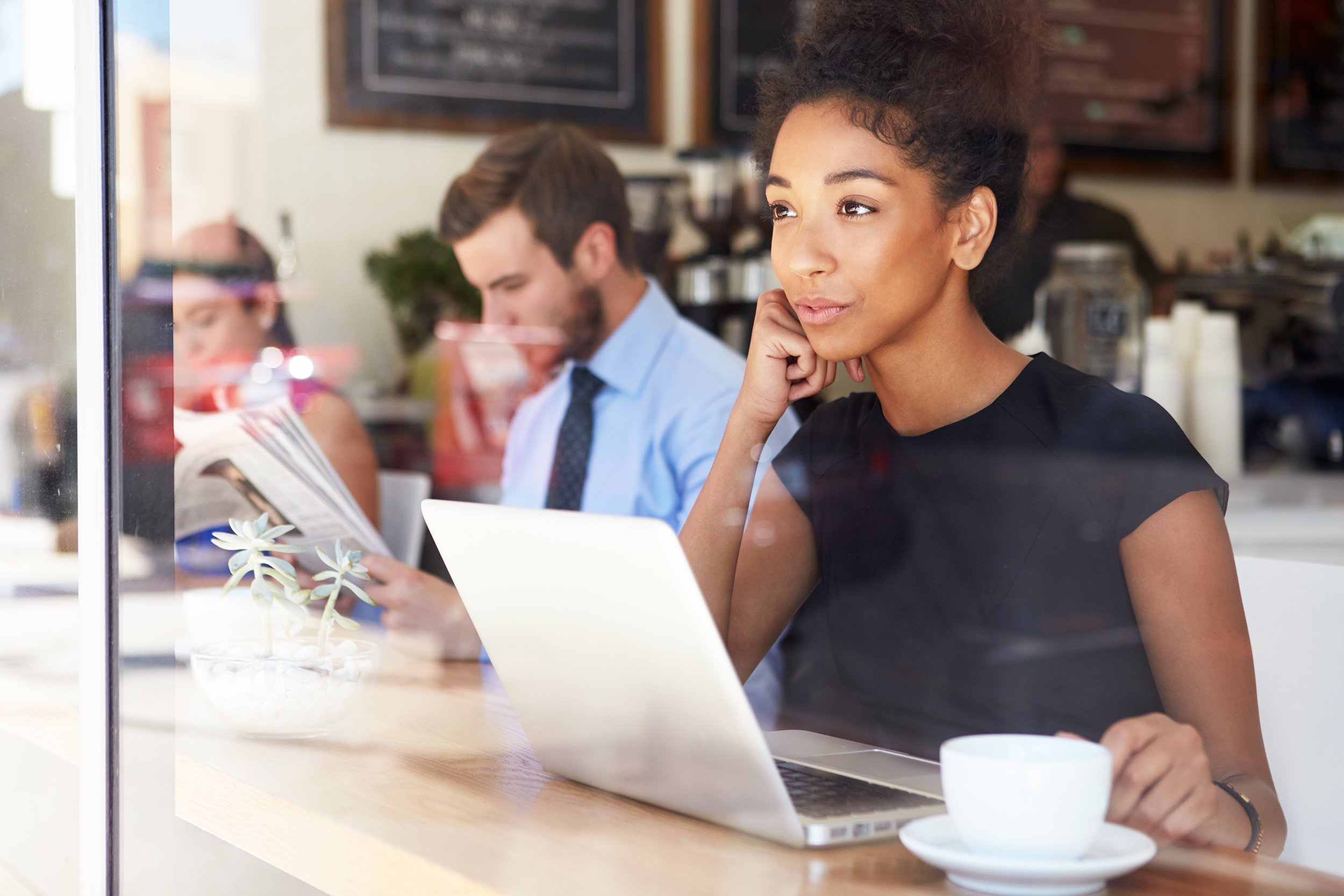 businesswoman using laptop in coffee shop
