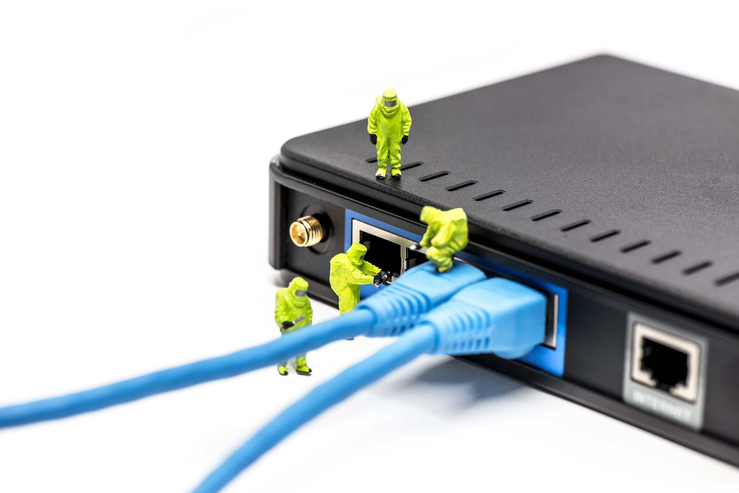 network engineers connecting cables to the network switch