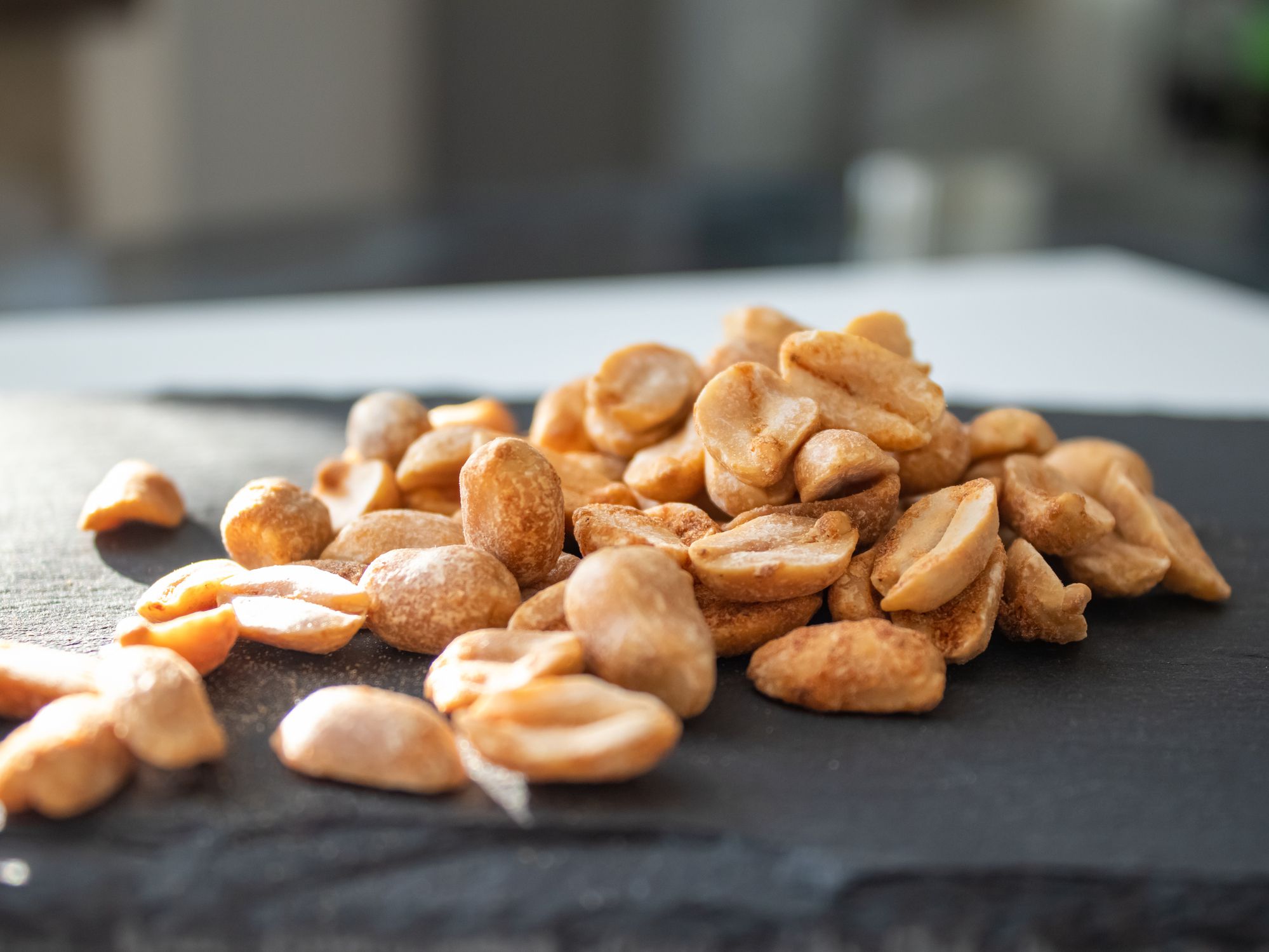 Roasted chili lemon peanuts on stone cutting board