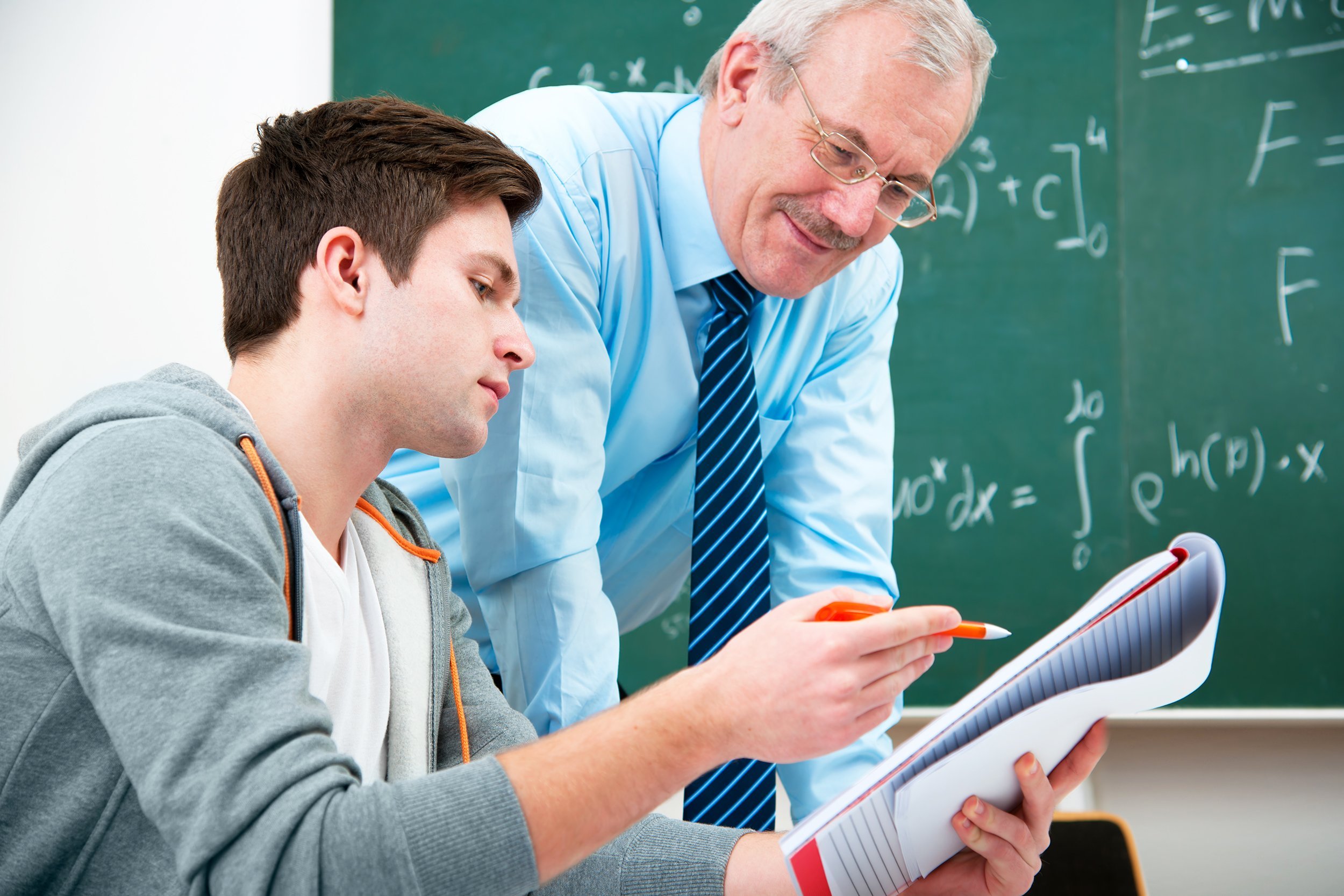 male teacher helping male student