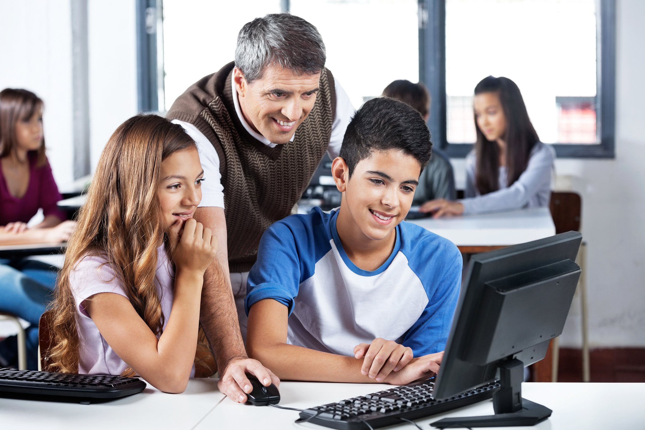 male teacher helping students