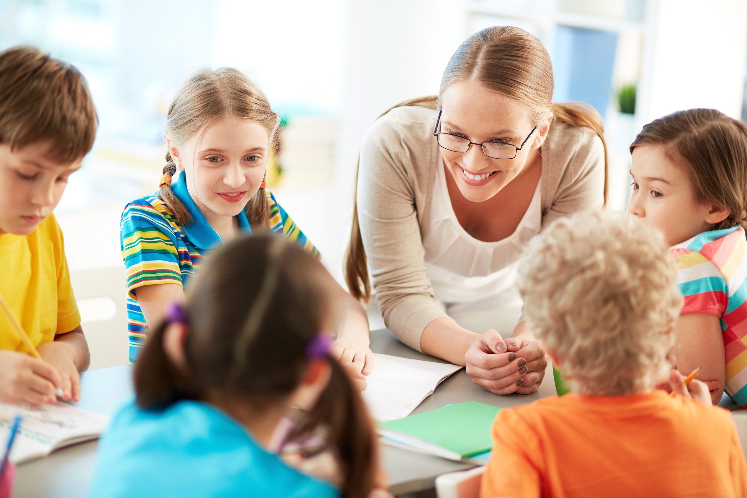 female teacher helping students