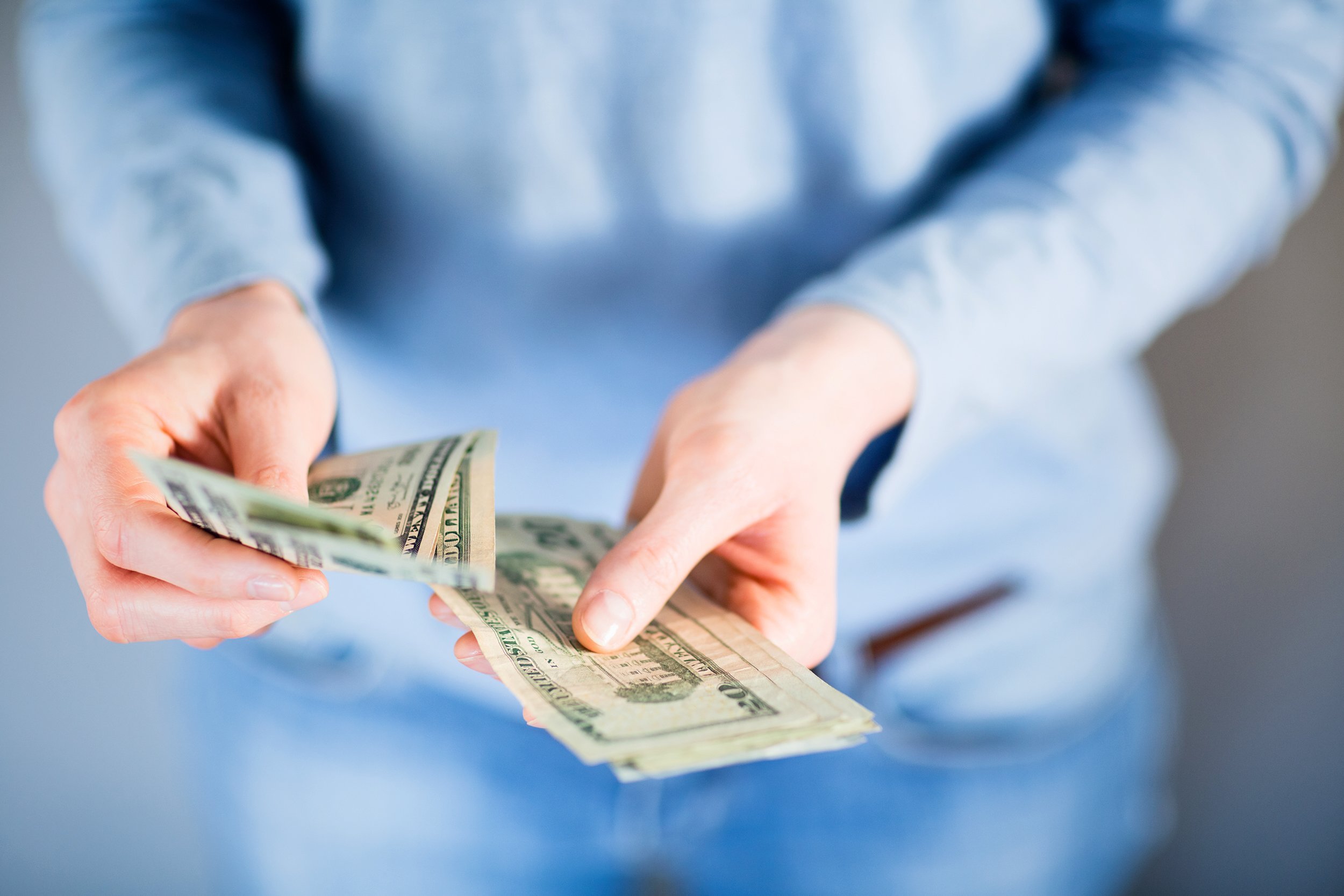 Woman paying cash in U.S. dollars
