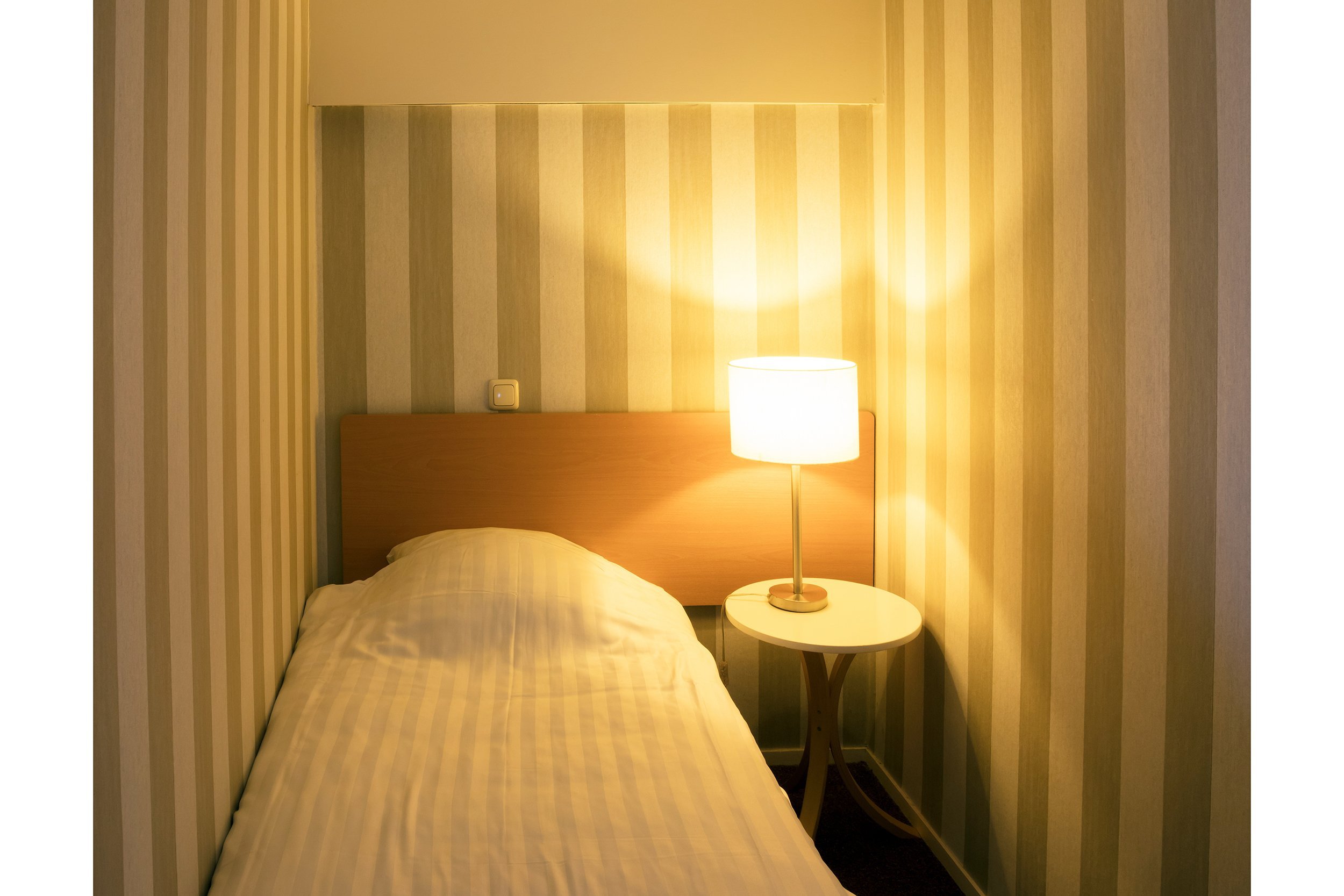 Small hotel room with a lamp