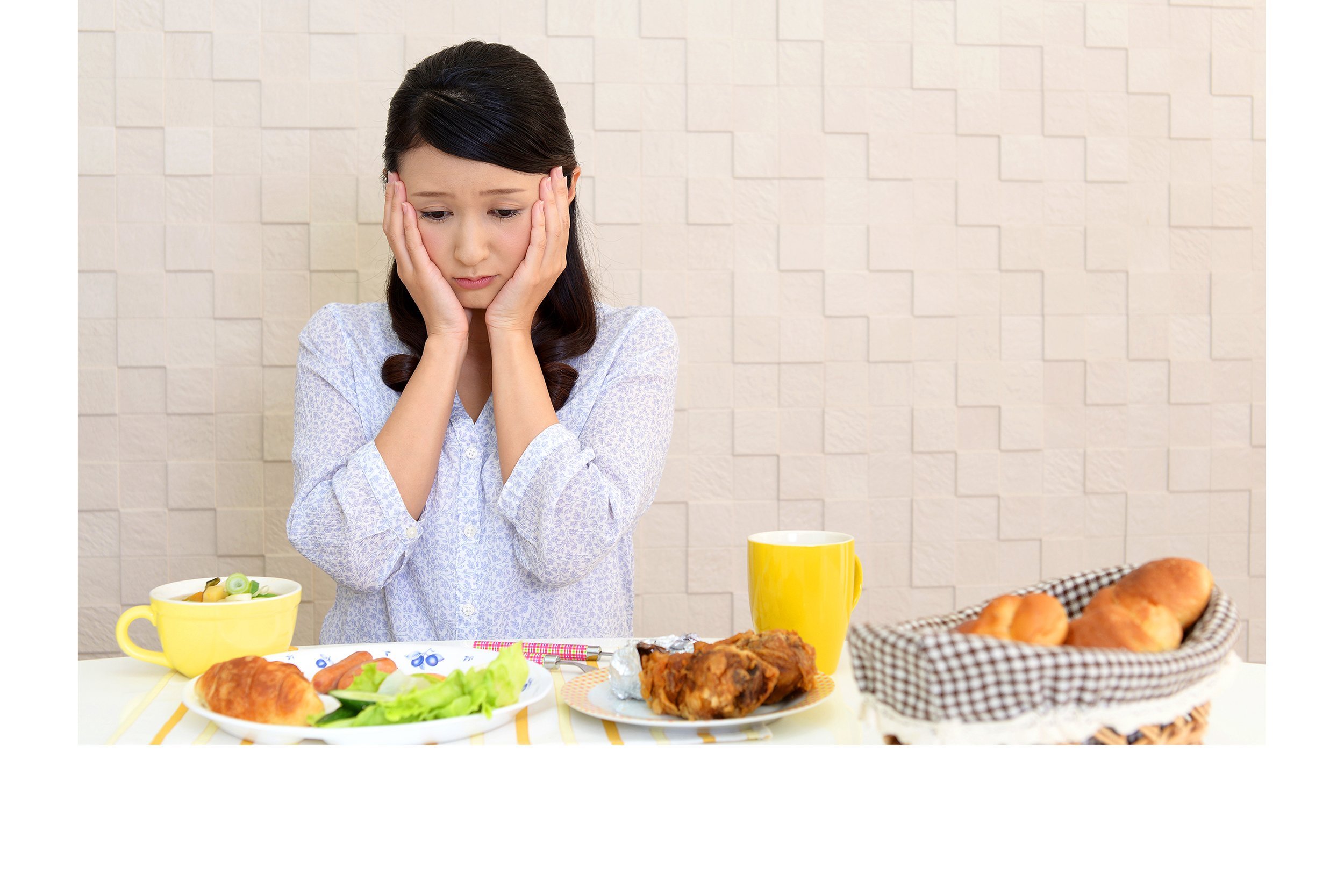 Woman with no appetite in front of food