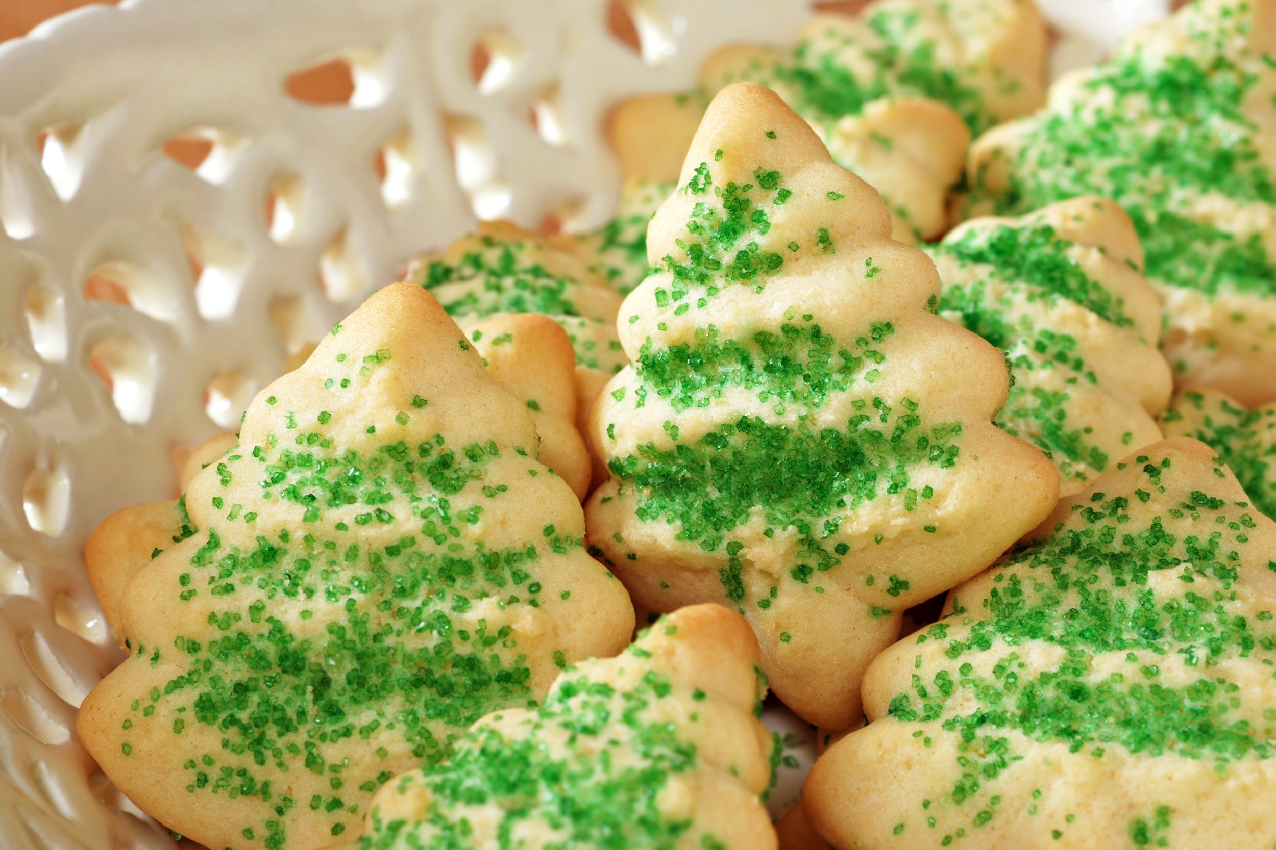Christmas tree spritz cookies with green sprinkles in a bowl