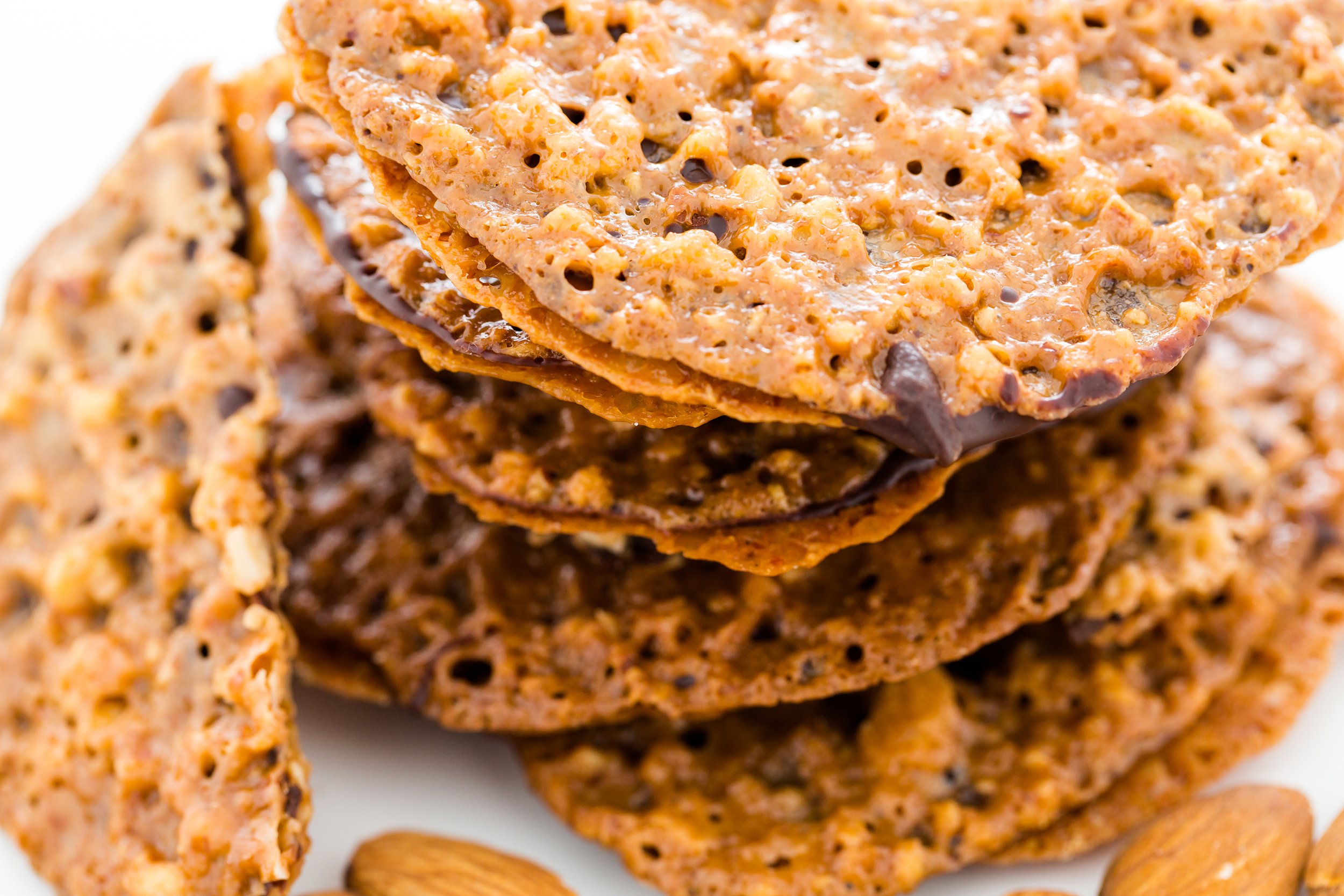 Florentine or almond lace cookies with chocolate in a stack