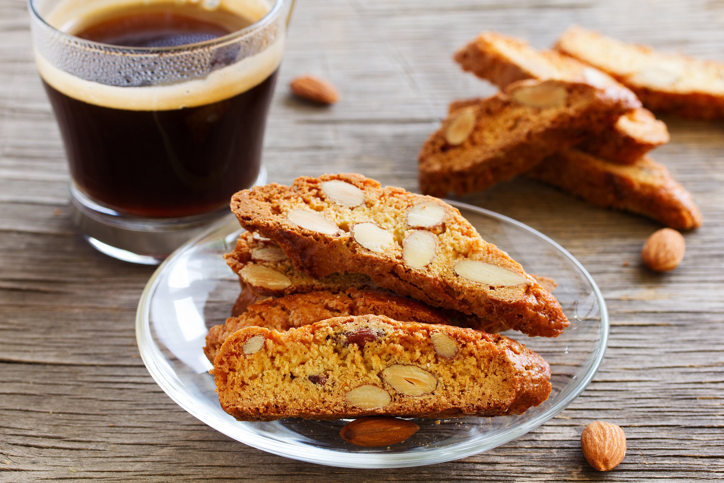 Almond biscotti cookies on a plate with a cup of coffee