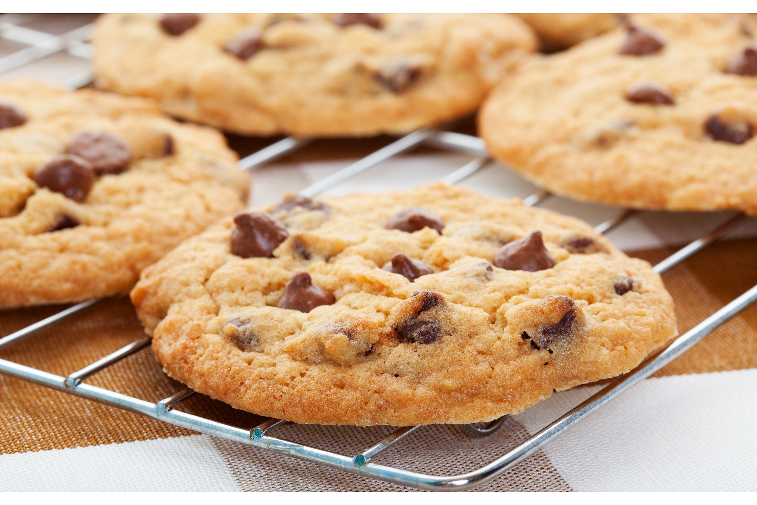 Chocolate chip cookies cooling on a wire rack