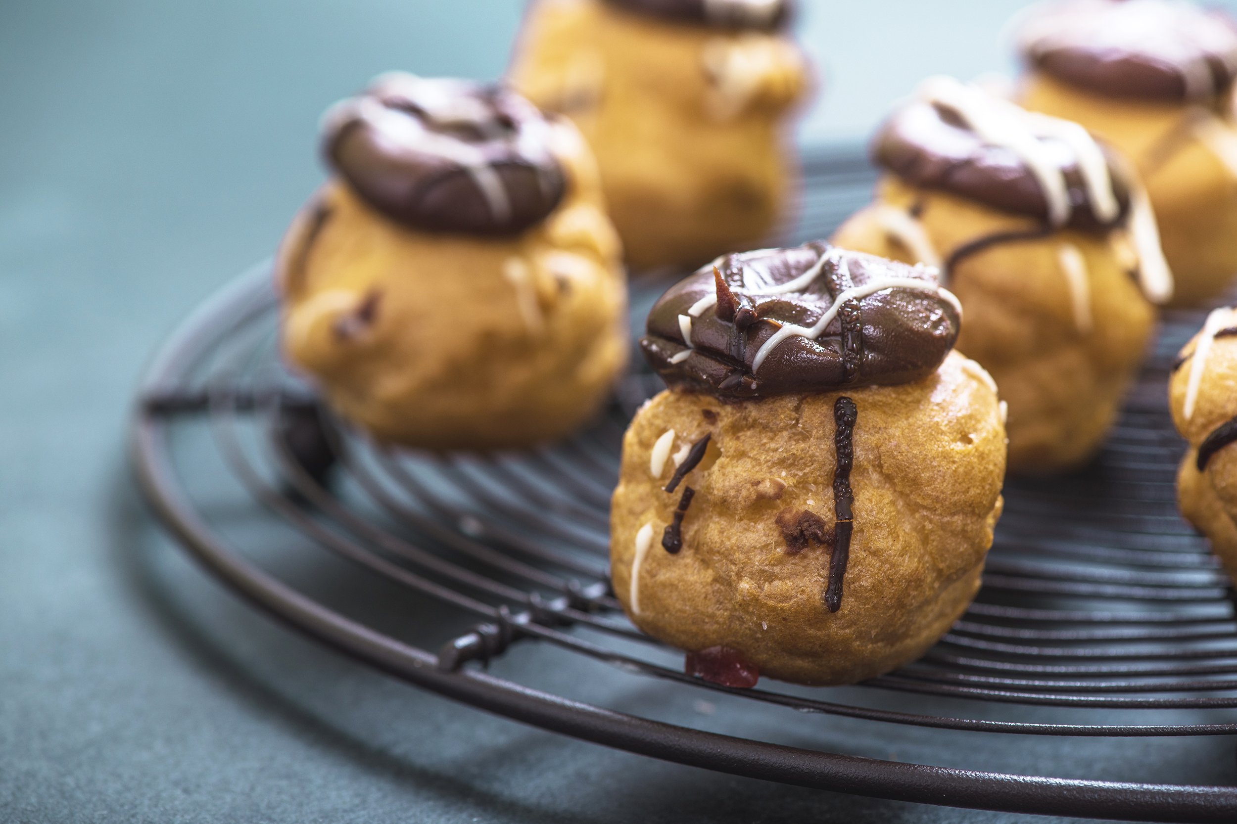 Mini cream puffs with chocolate on top