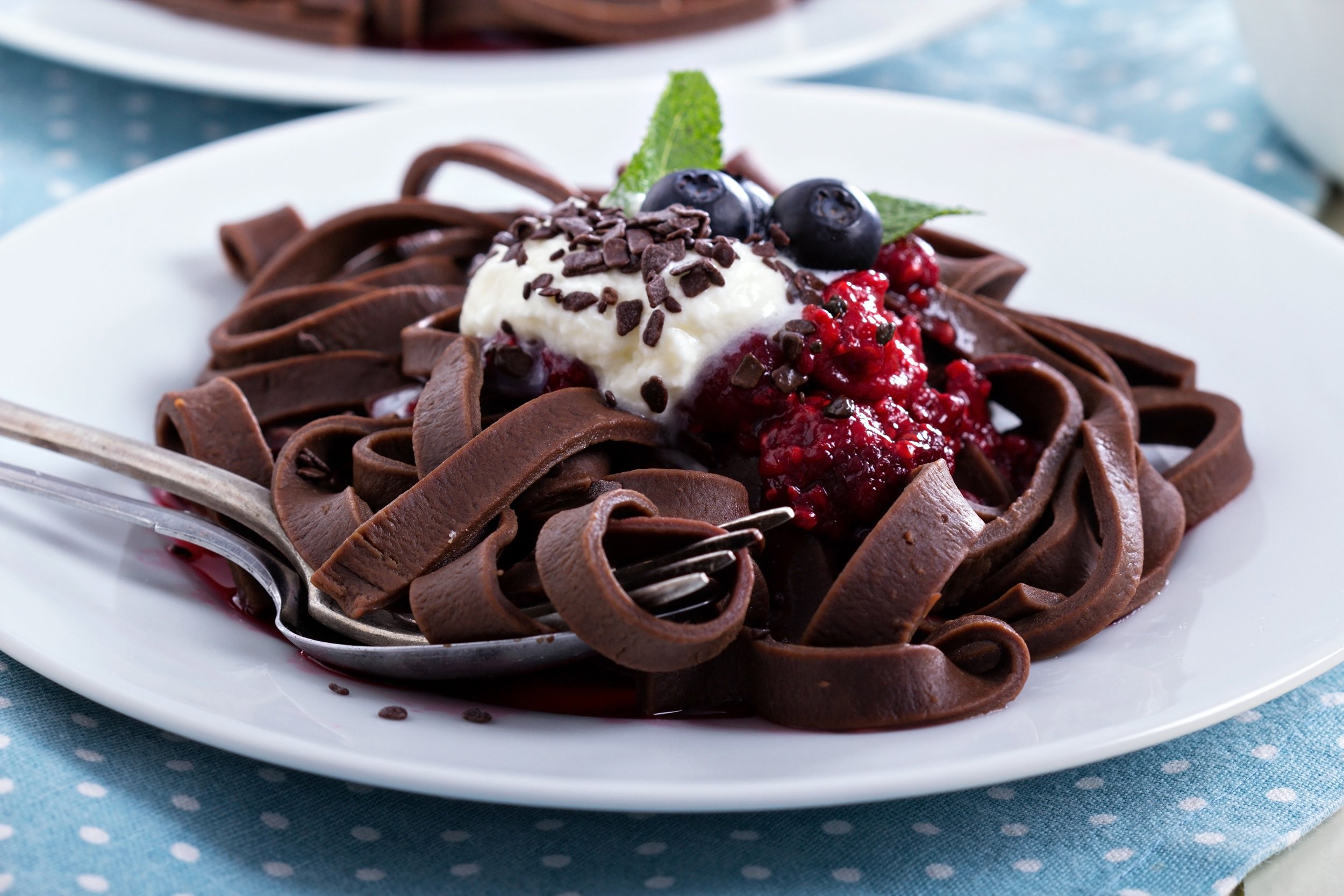 Chocolate pasta with cream on top