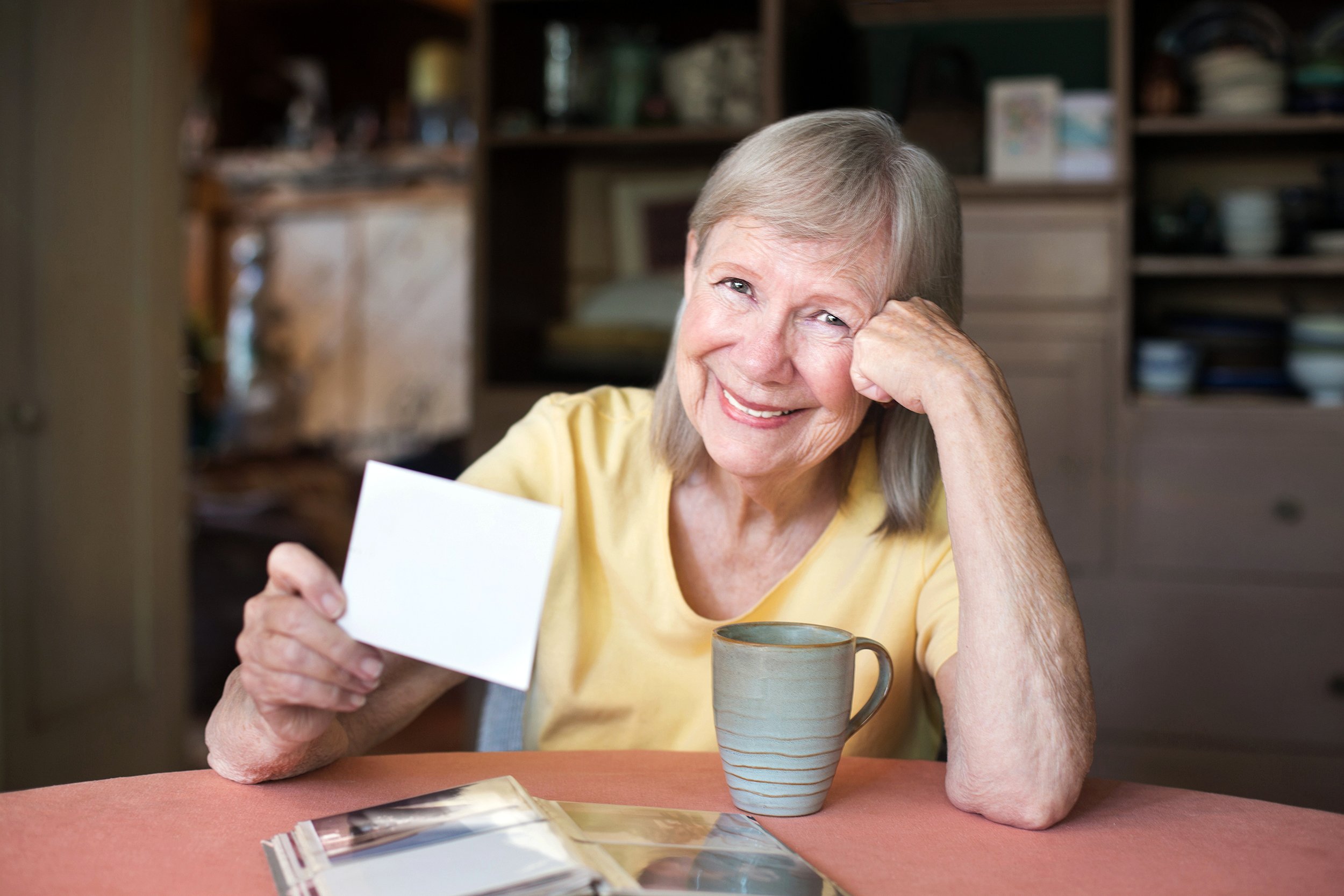 Single senior female looking at photos at home