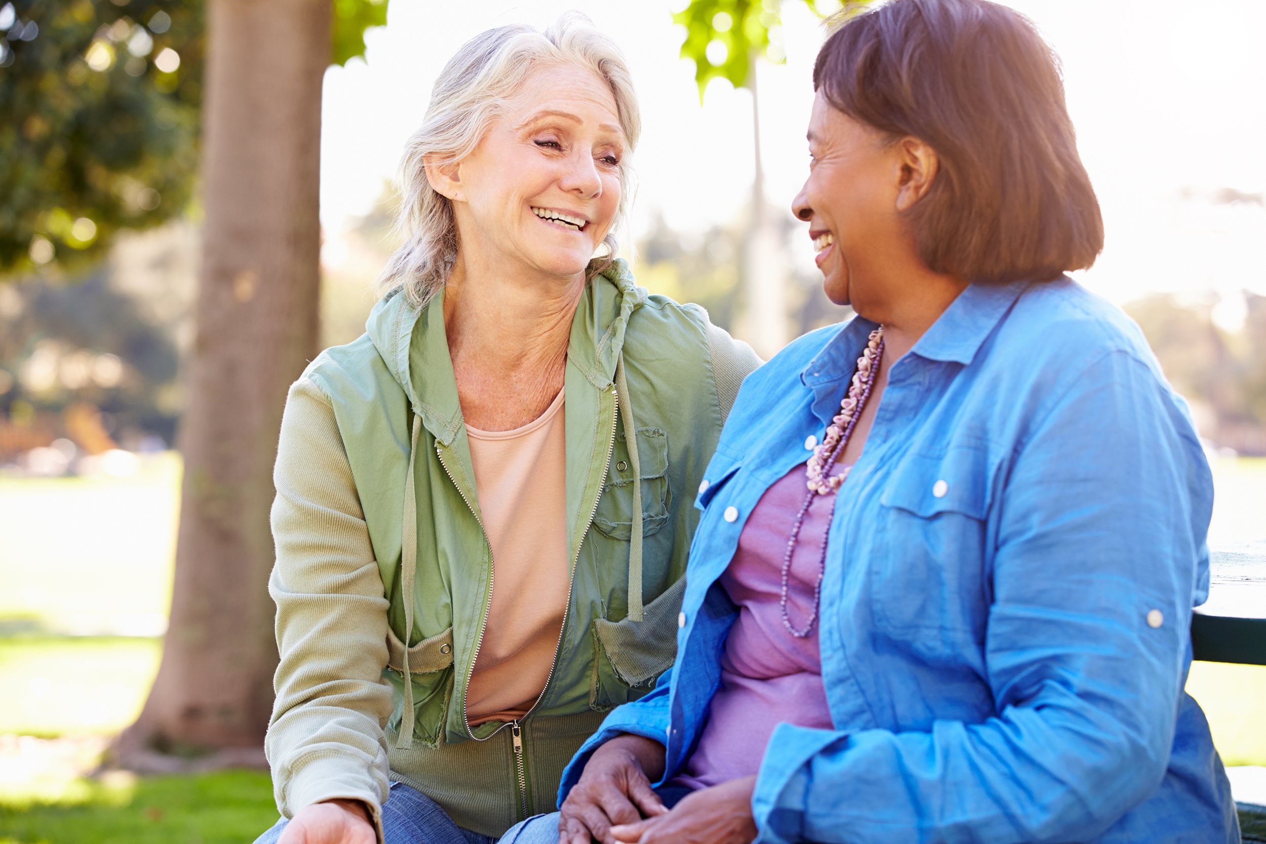 Two senior women talking outside