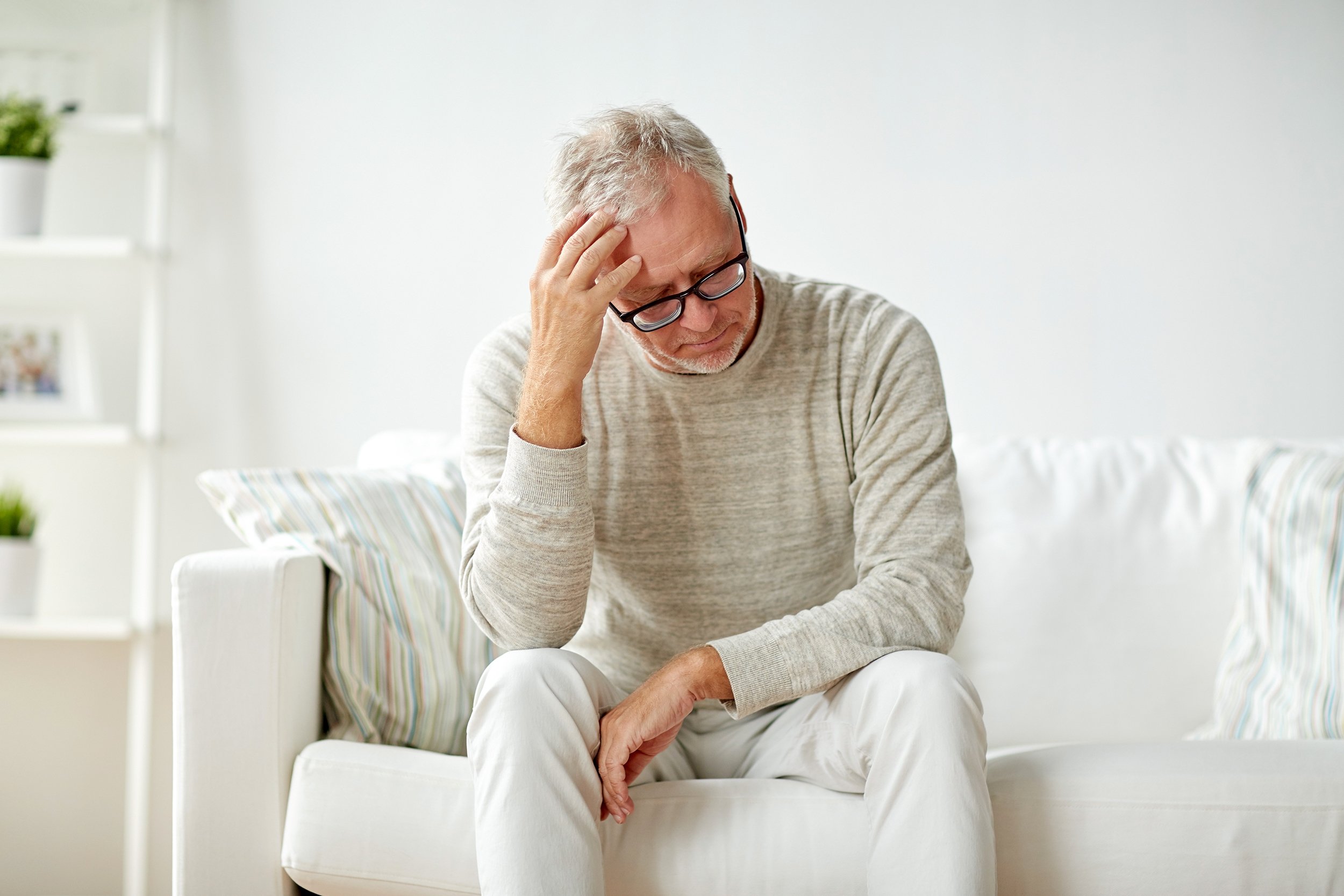Senior man looking sad or lonely alone at home