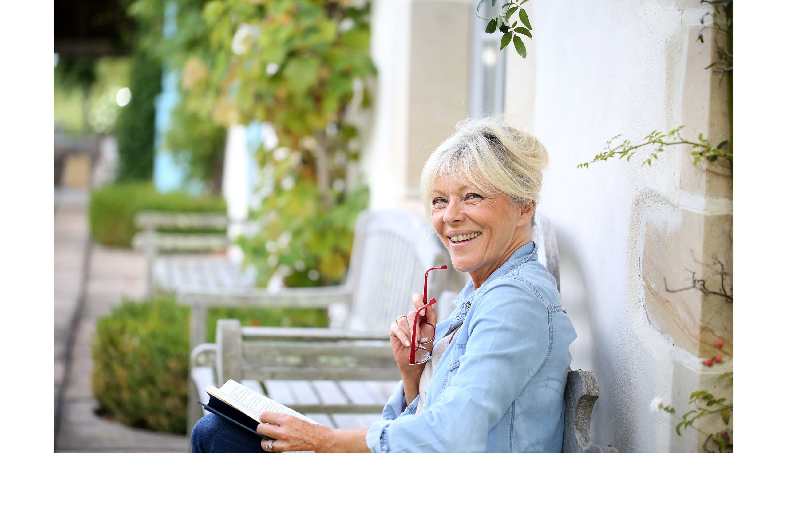 Smiling senior woman sitting on a bench outside