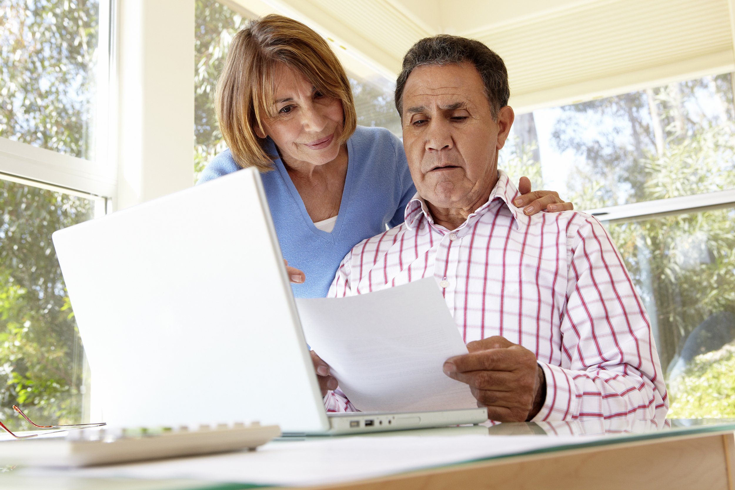 Senior couple looking stressed out at home