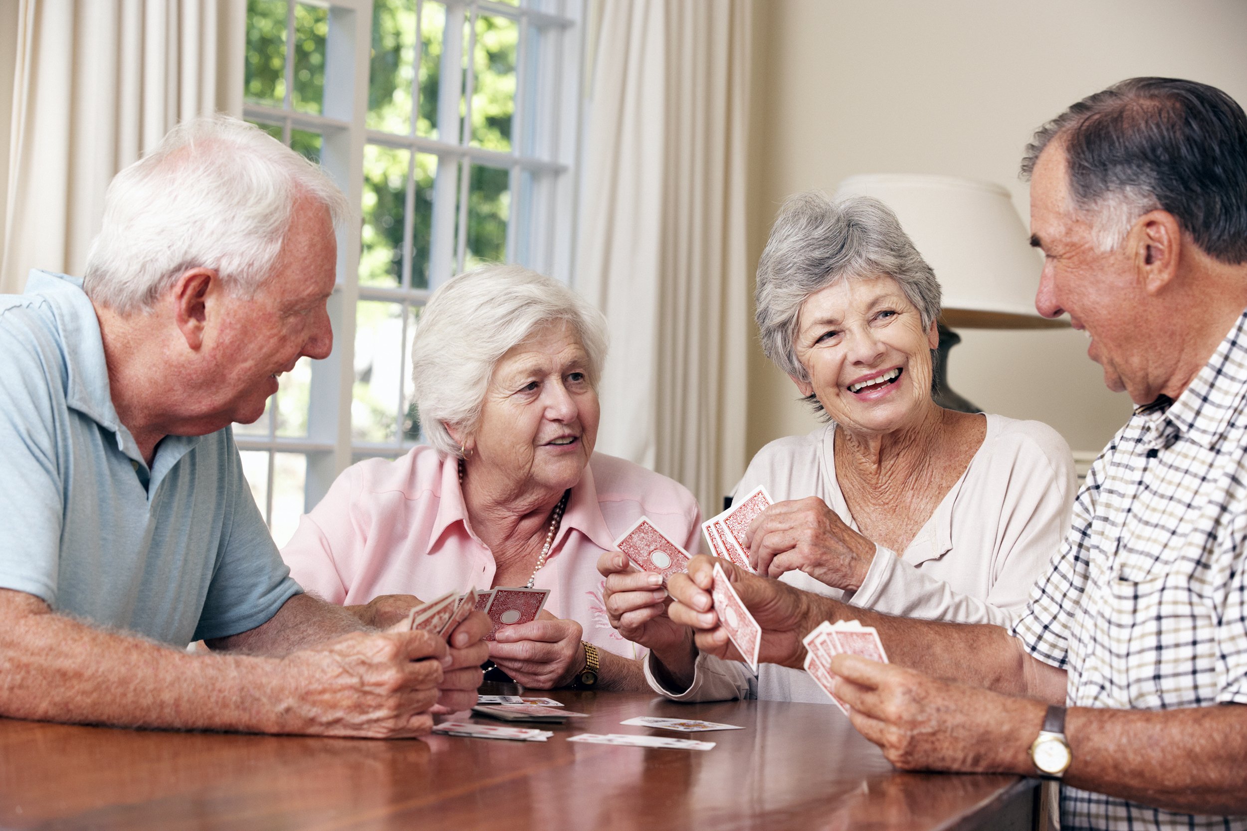 Group of seniors playing cards together
