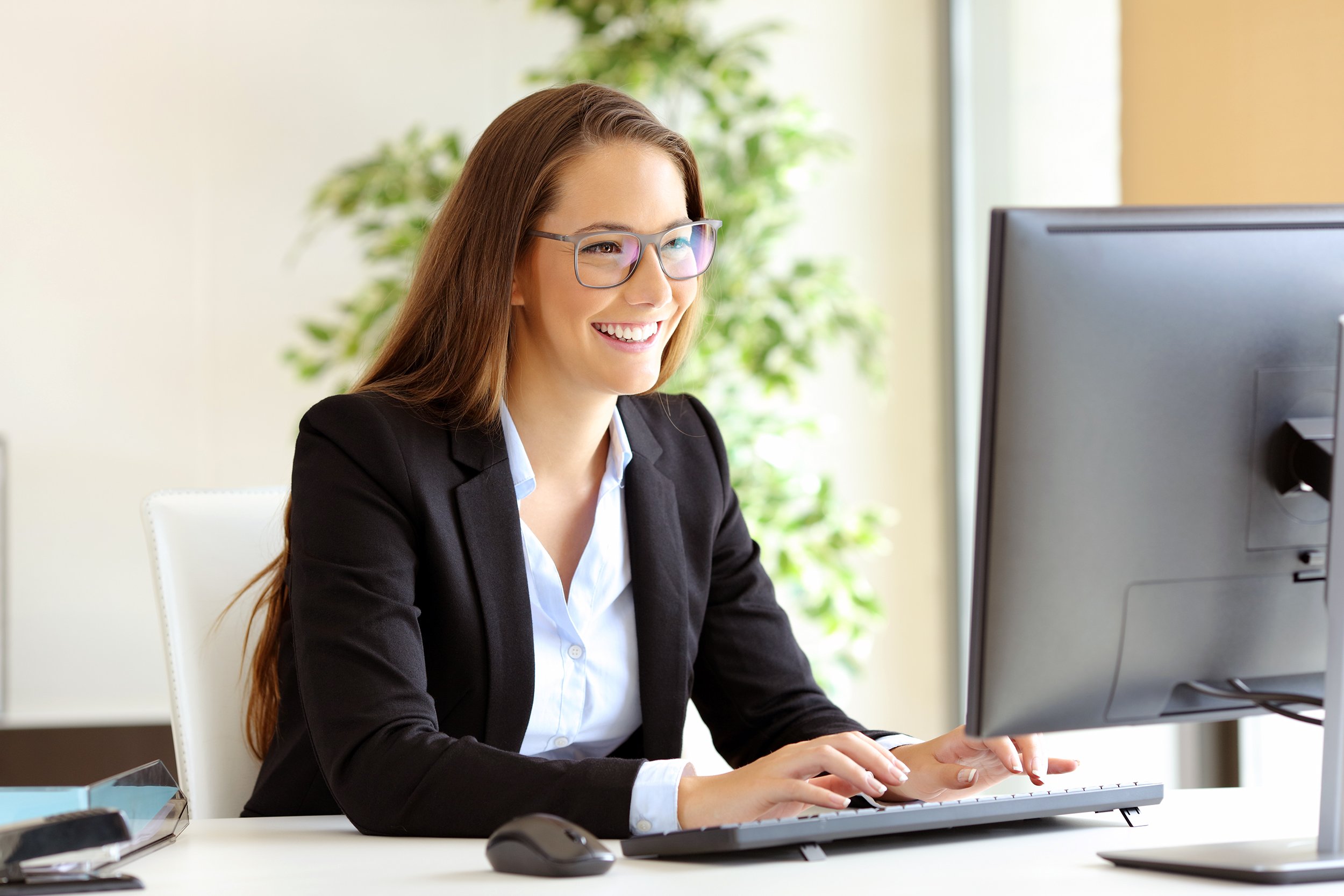 Business woman working on a computer at a desk