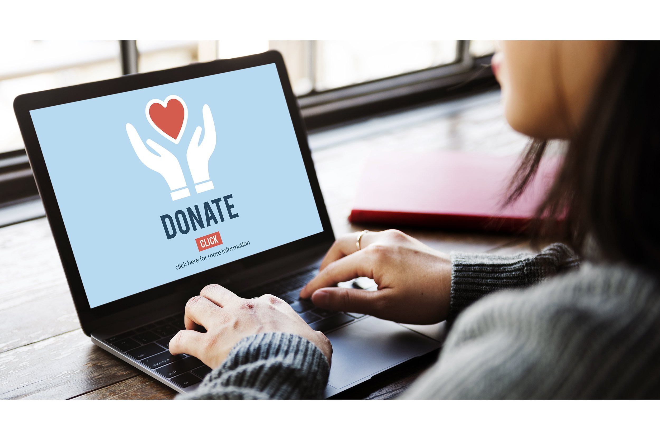 Woman on her laptop donating to a charity online