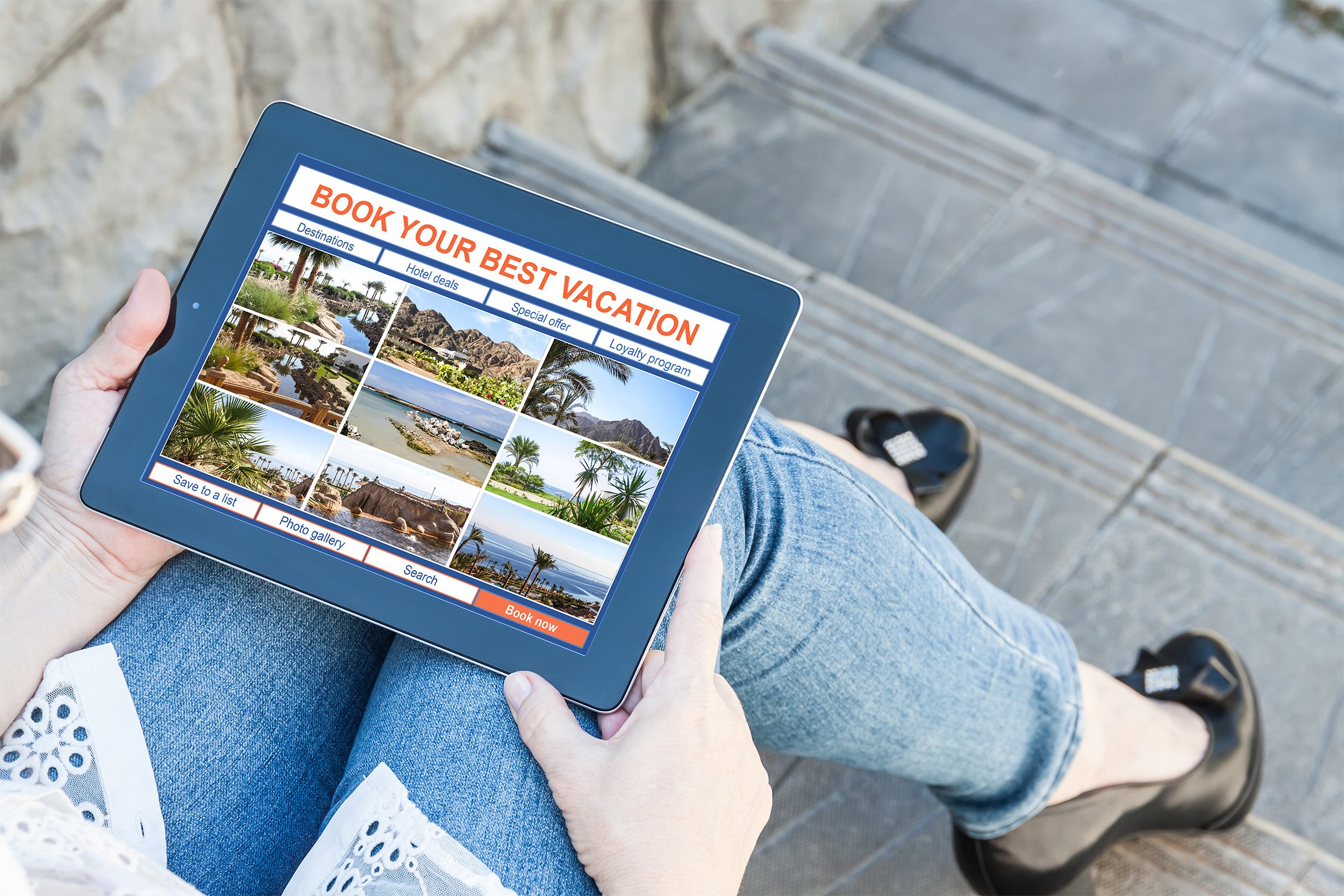 Woman looking at travel site photos on her tablet