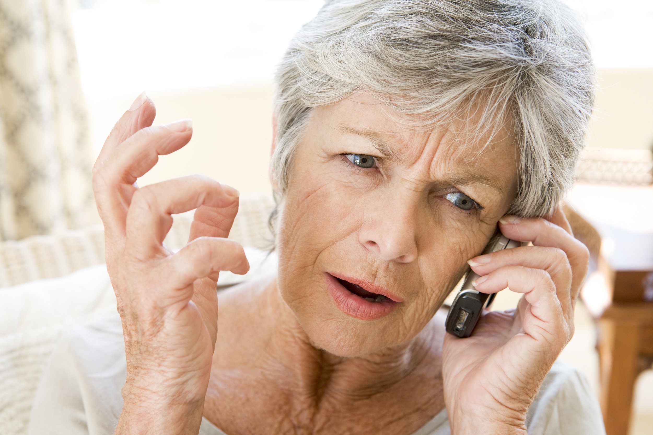 Senior woman looking unhappy on the phone