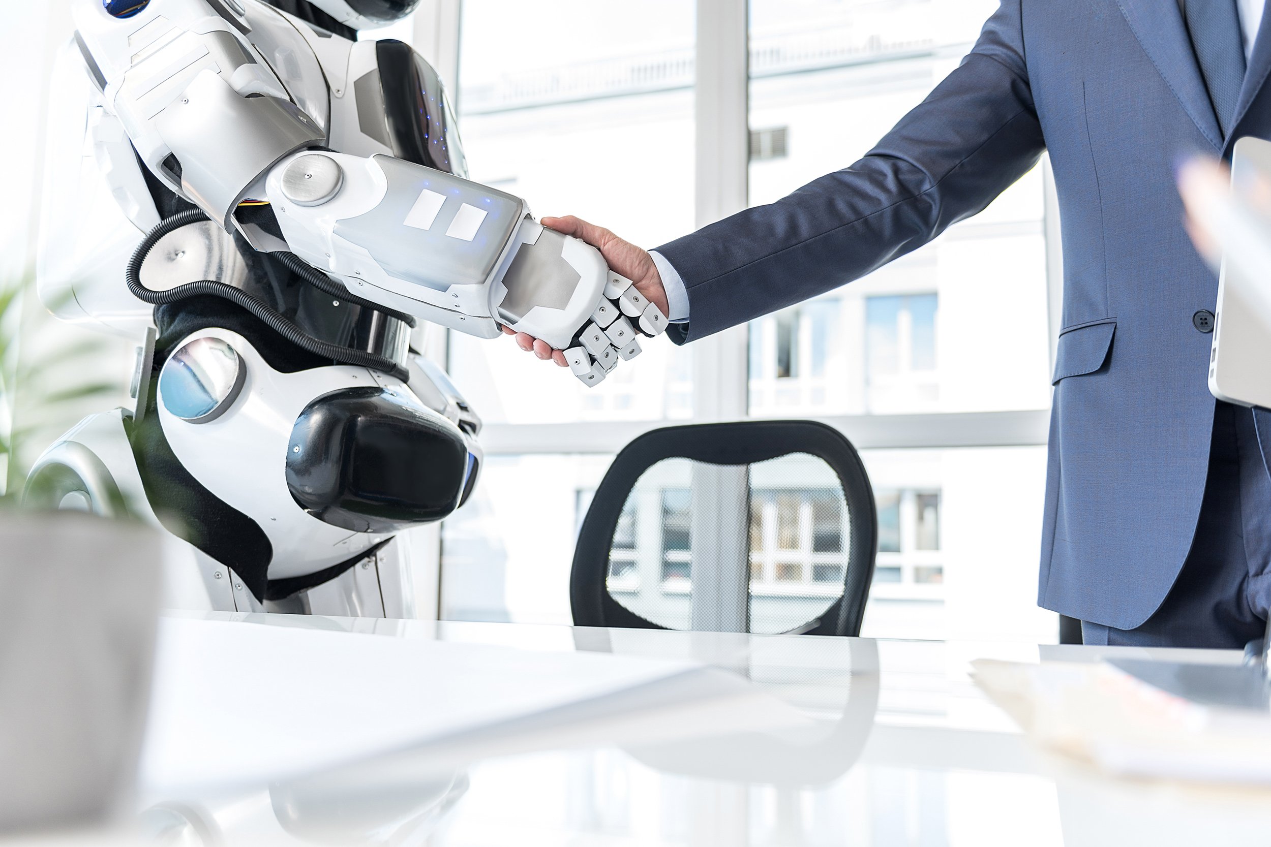 man is shaking hand with cyborg