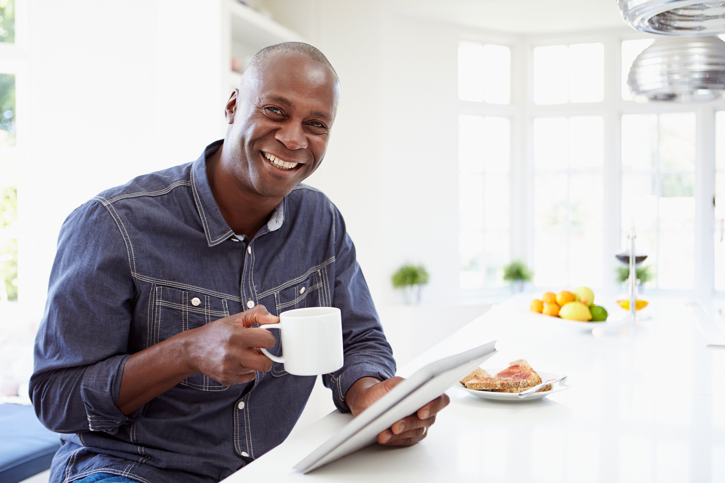 African American man using digital tablet at home