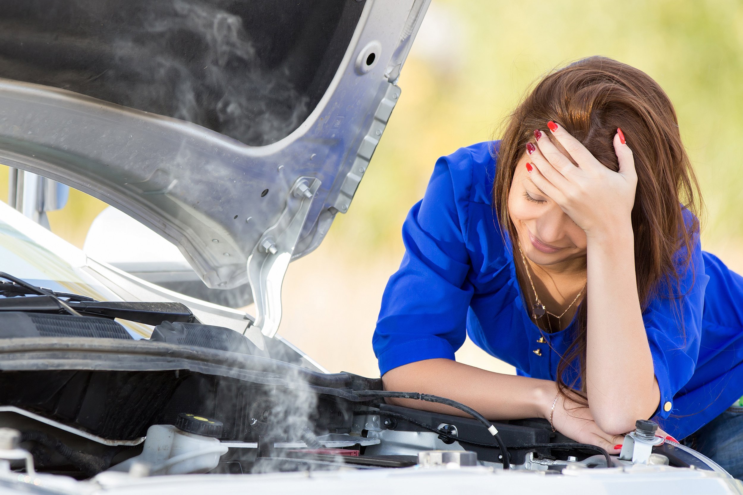 woman with broken down car with hood open