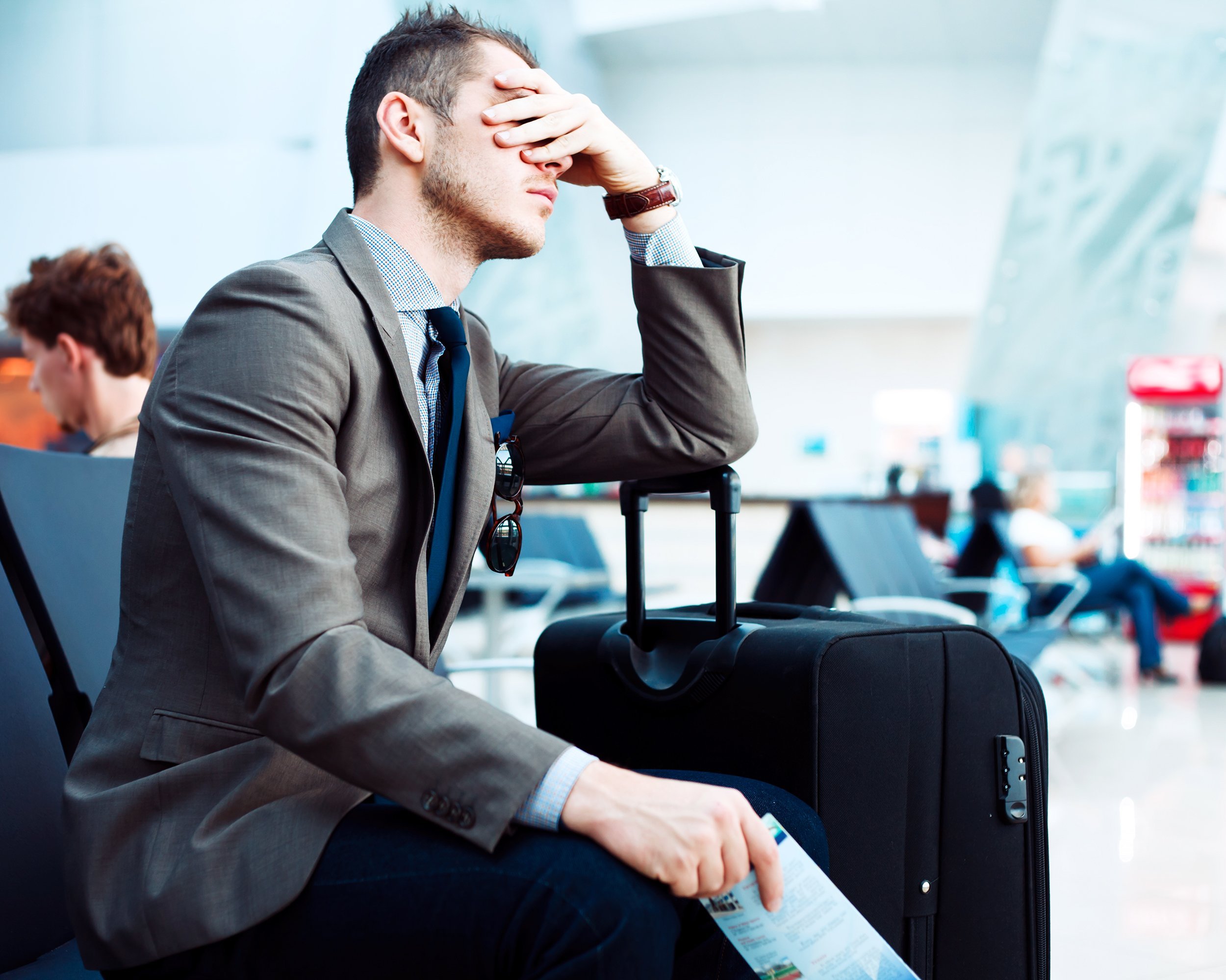 man frustrated with delayed flight