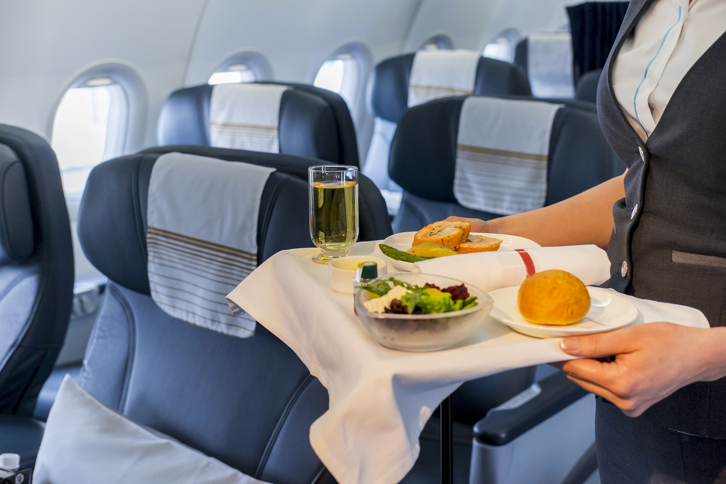 stewardess serving lunch on airplane
