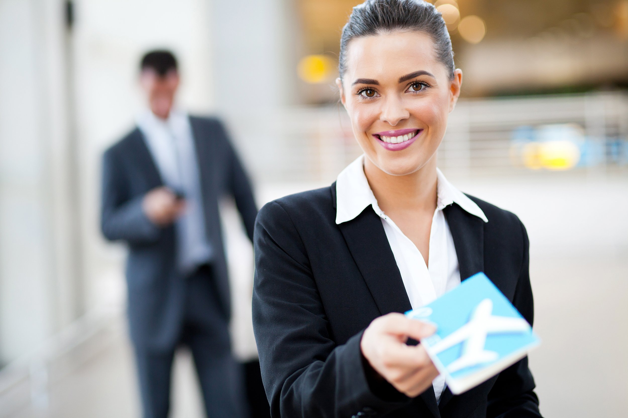 businesswoman handing over air ticket at airport check in counter
