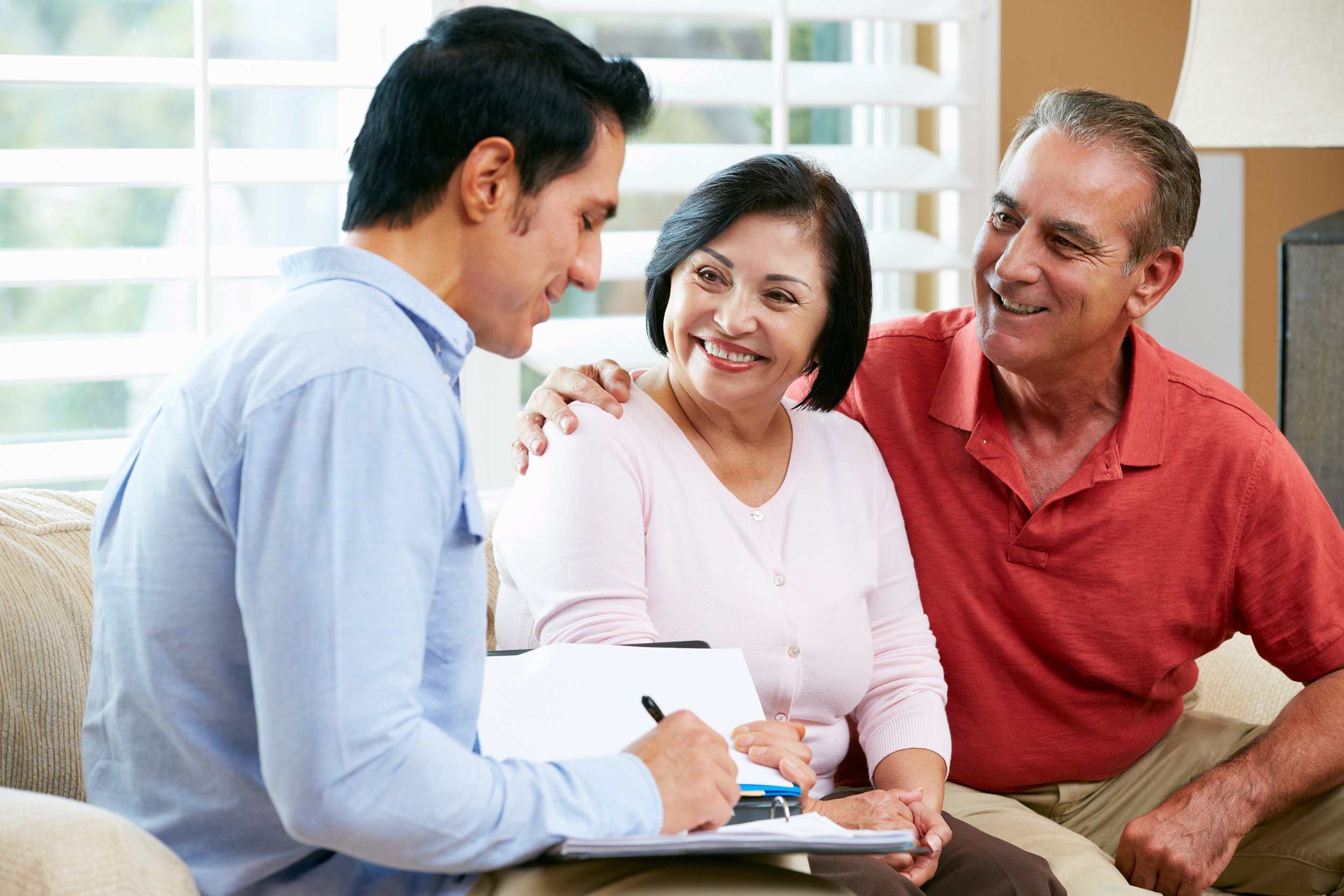 Financial advisor talking to senior couple at home