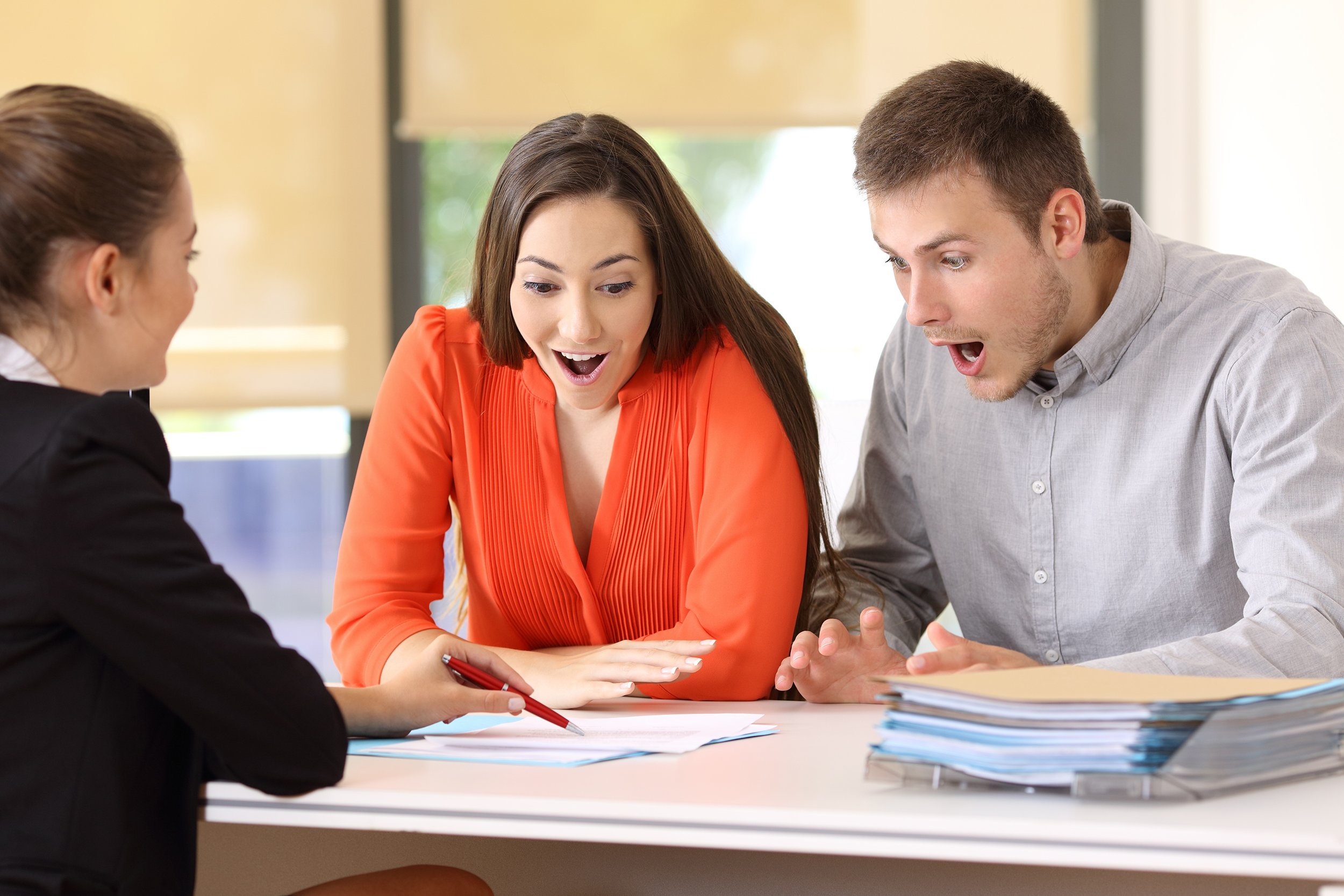 Two amazed customers meeting in an office