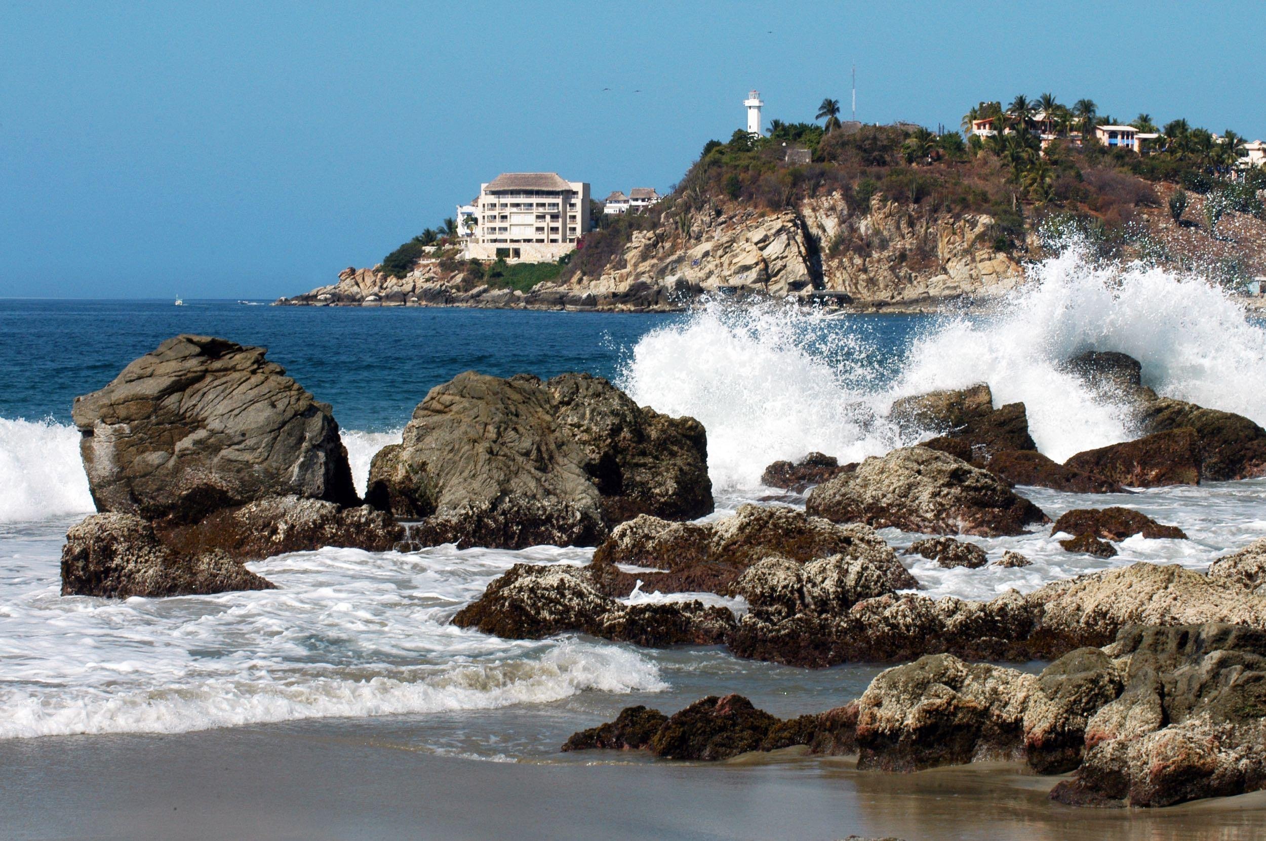 bay in Puerto Escondido with hotel and lighthouse, Mexico