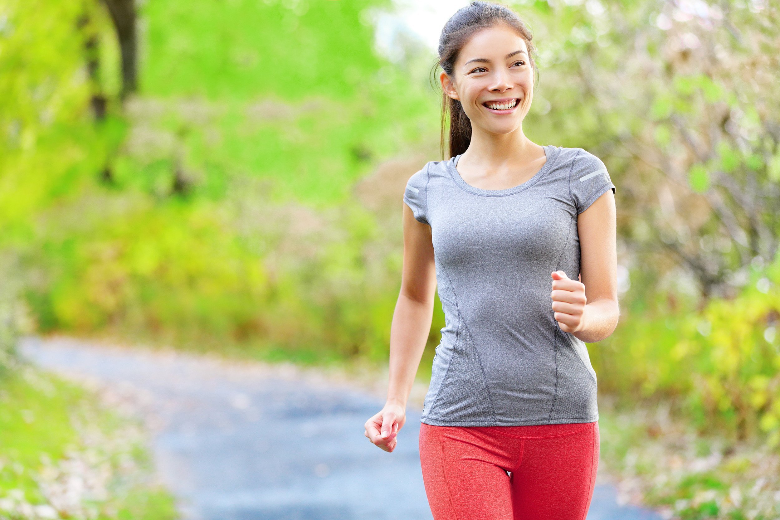 woman fast-walking in the park