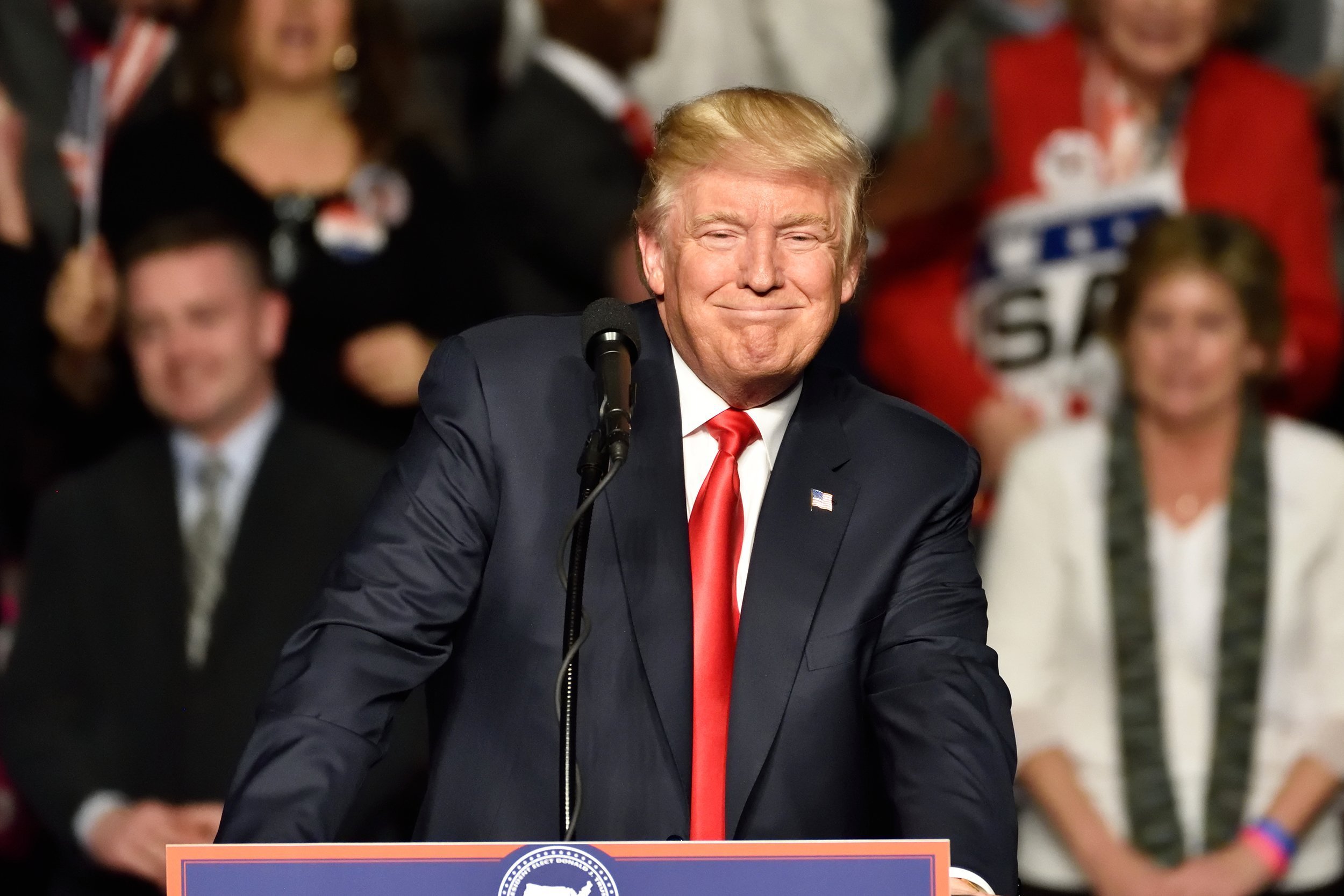 president-elect Donald Trump smiles as he pauses during a speech