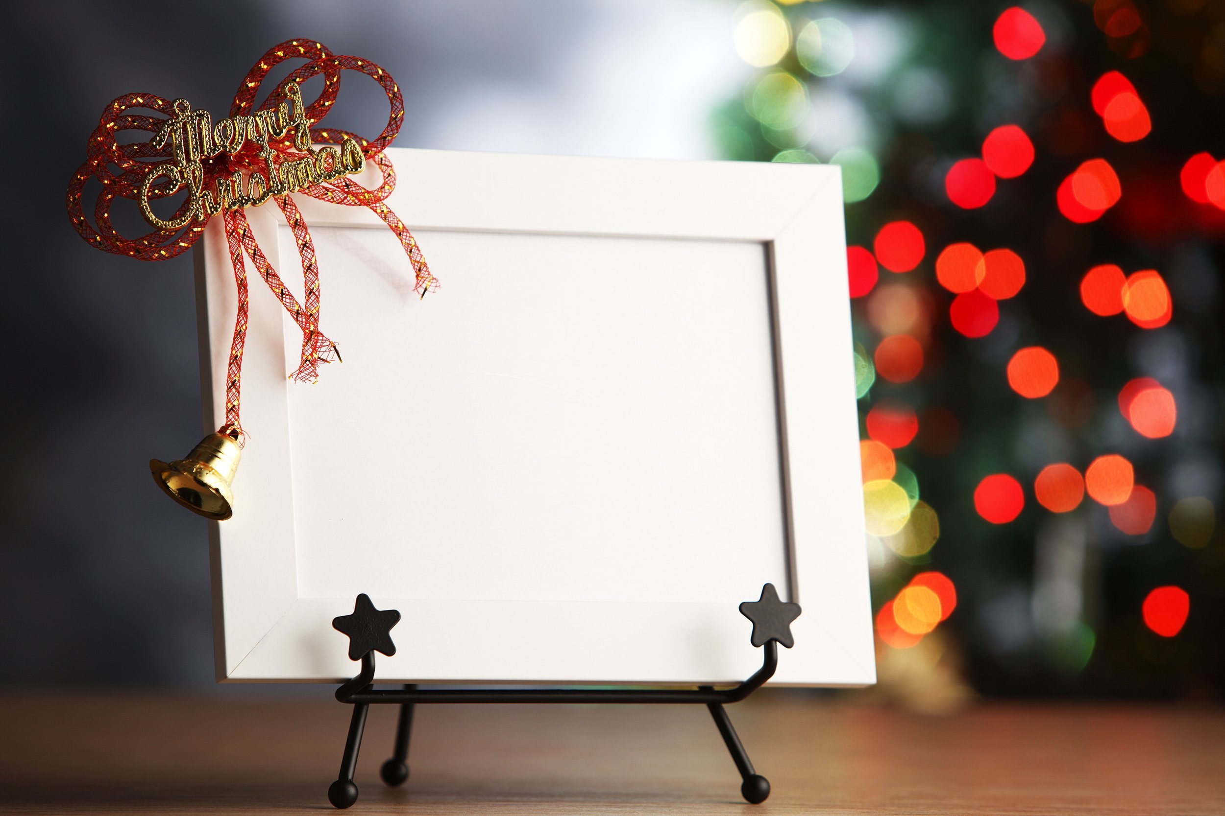 Christmas picture frame with a Christmas tree in the background