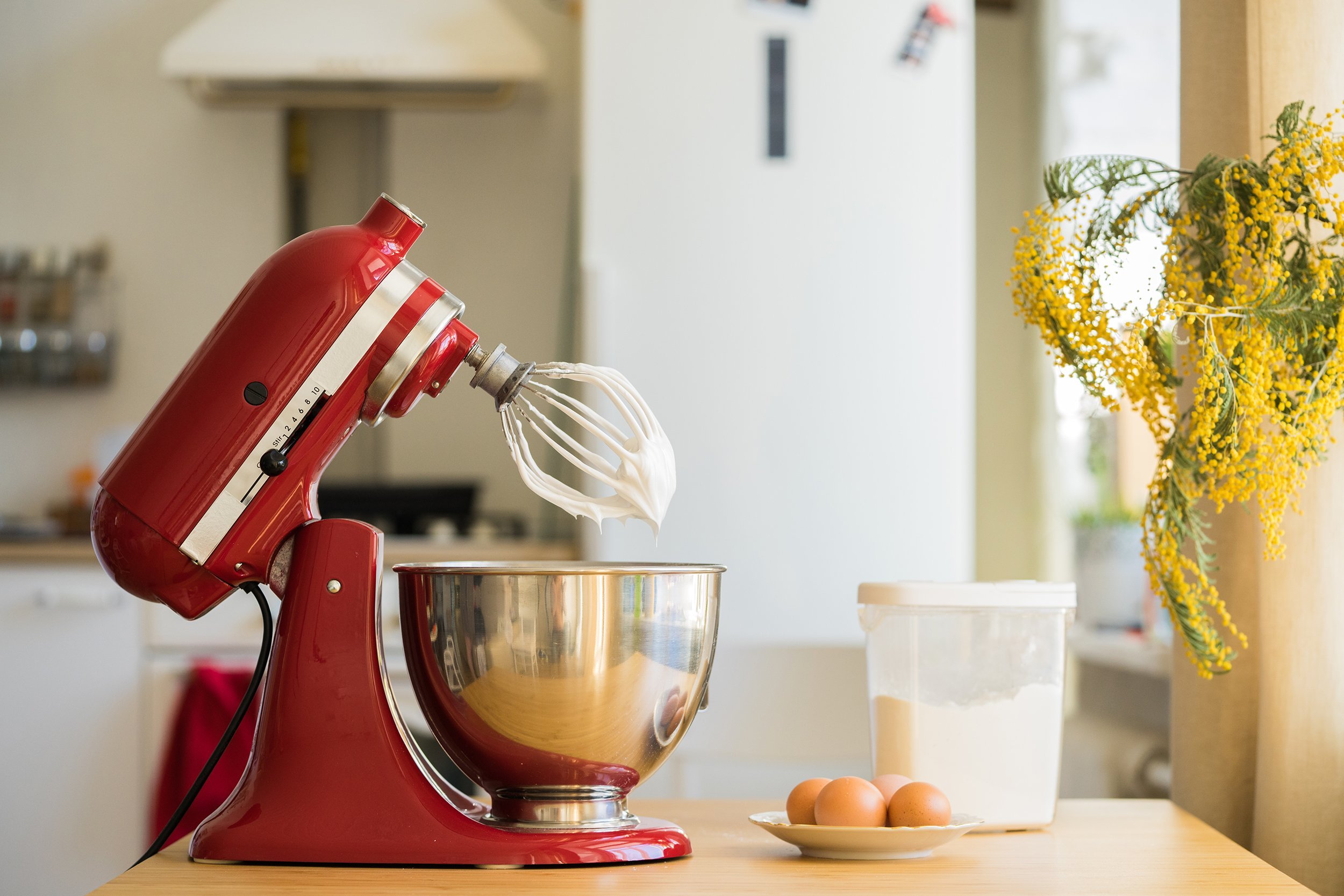 Red KitchenAid mixer on a counter in a kitchen