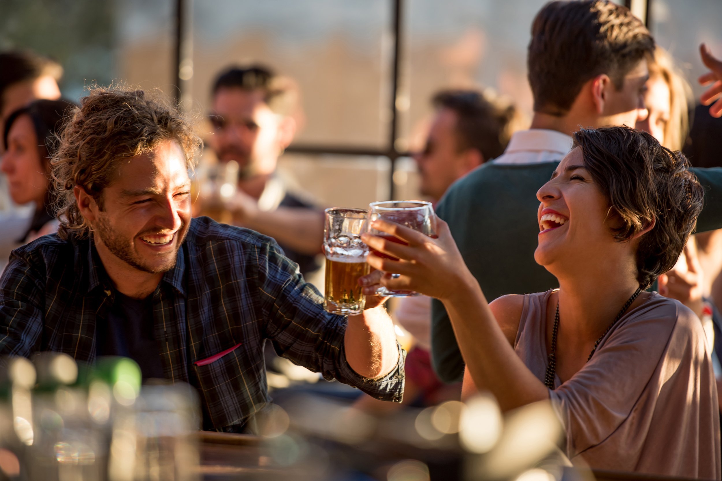 happy couple having drinks at a bar