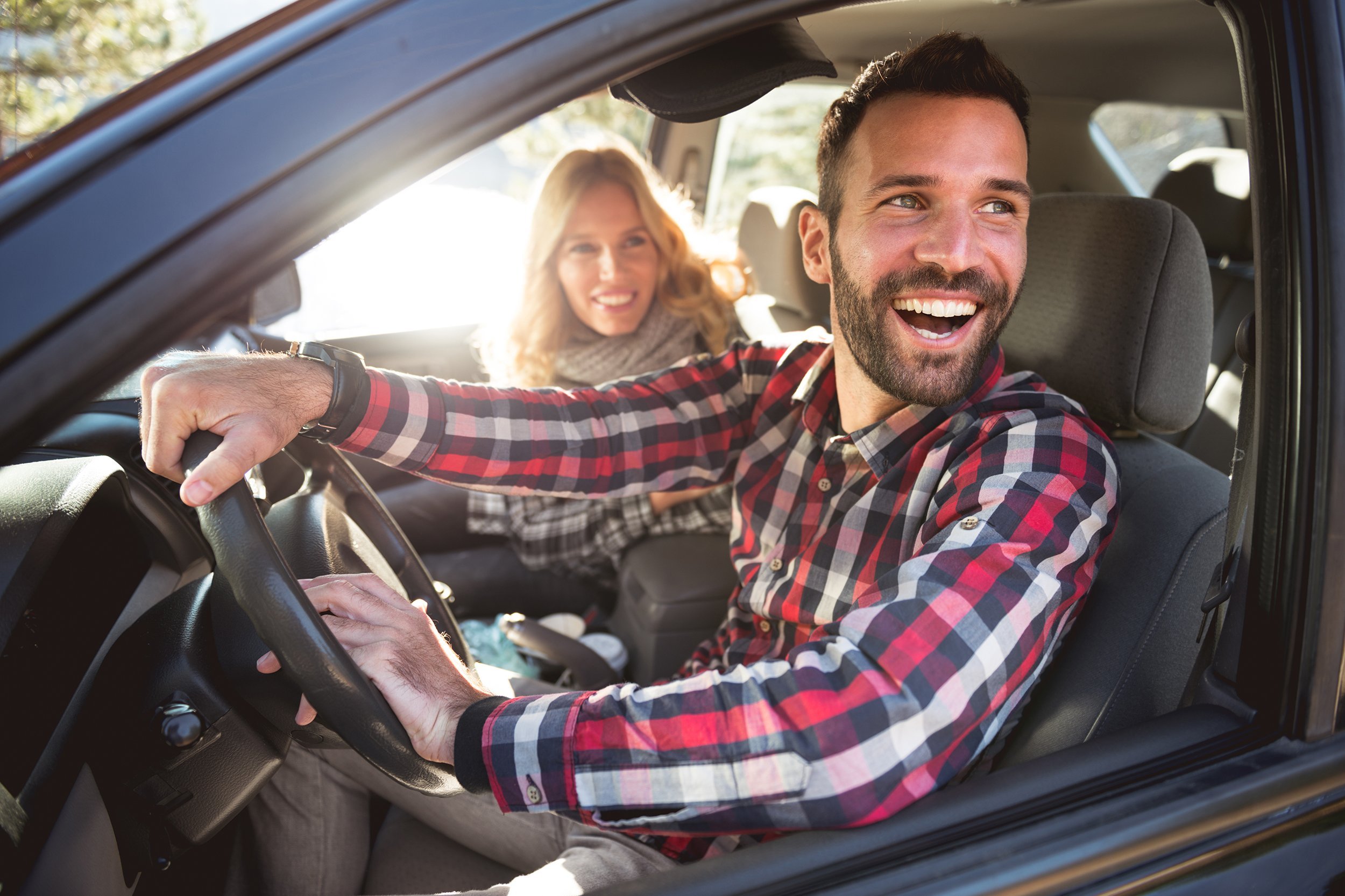 man and woman in car on roadtrip
