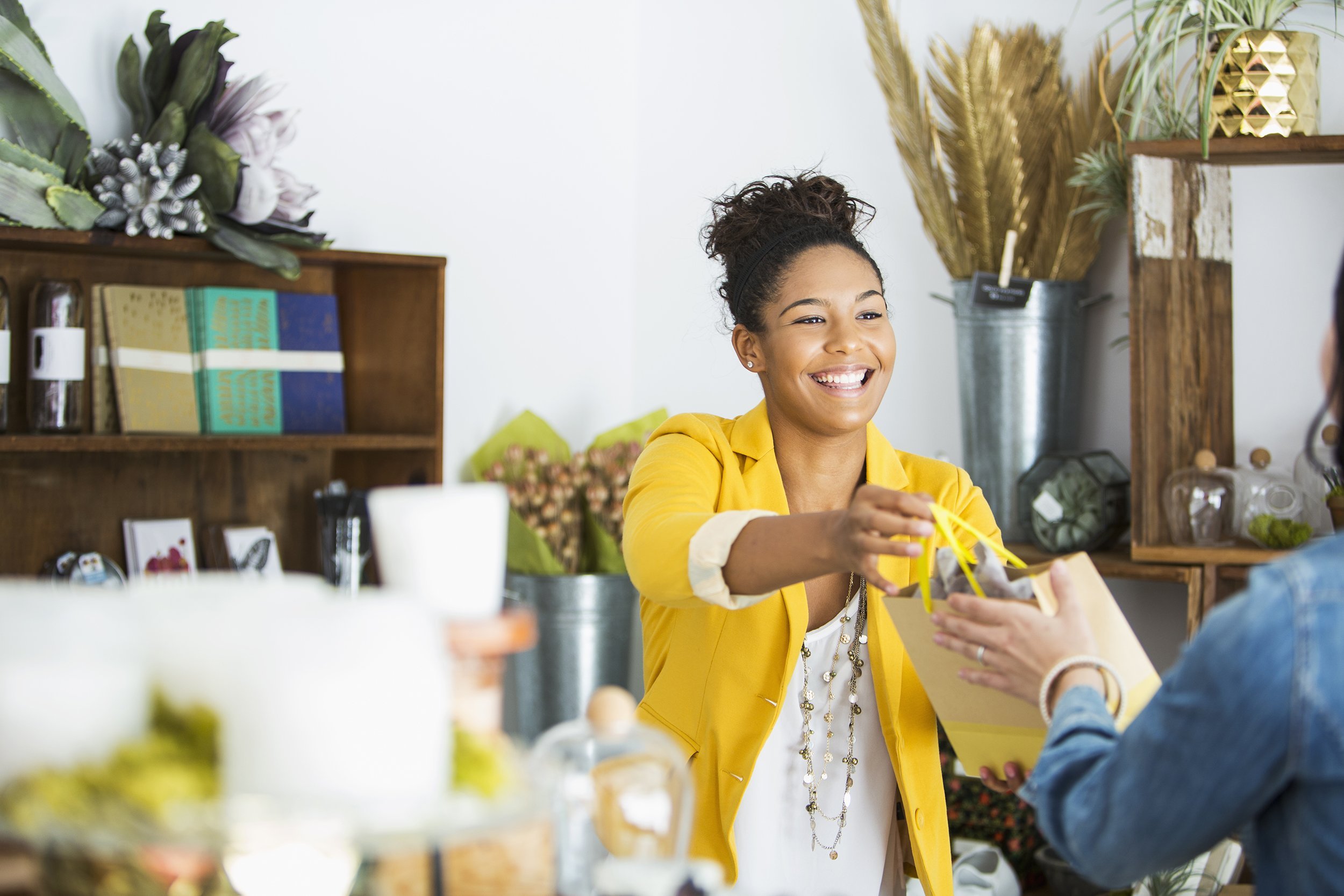 saleswoman helping customer in boutique