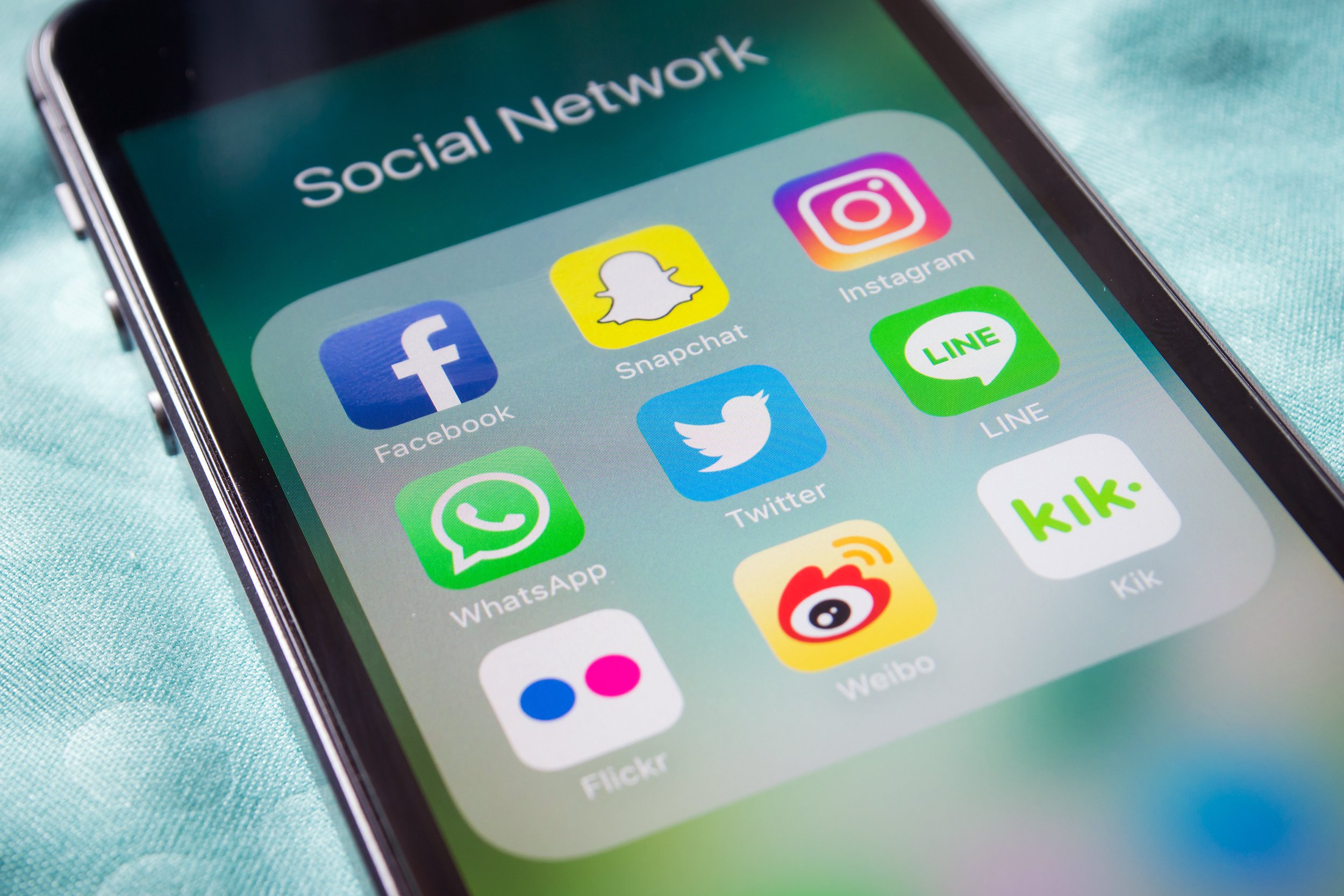 Closeup of phone with social media icons