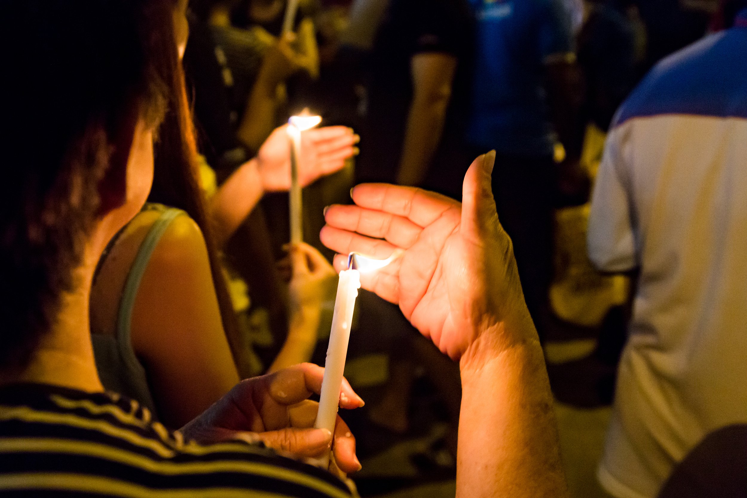 People attending a candlelight memorial