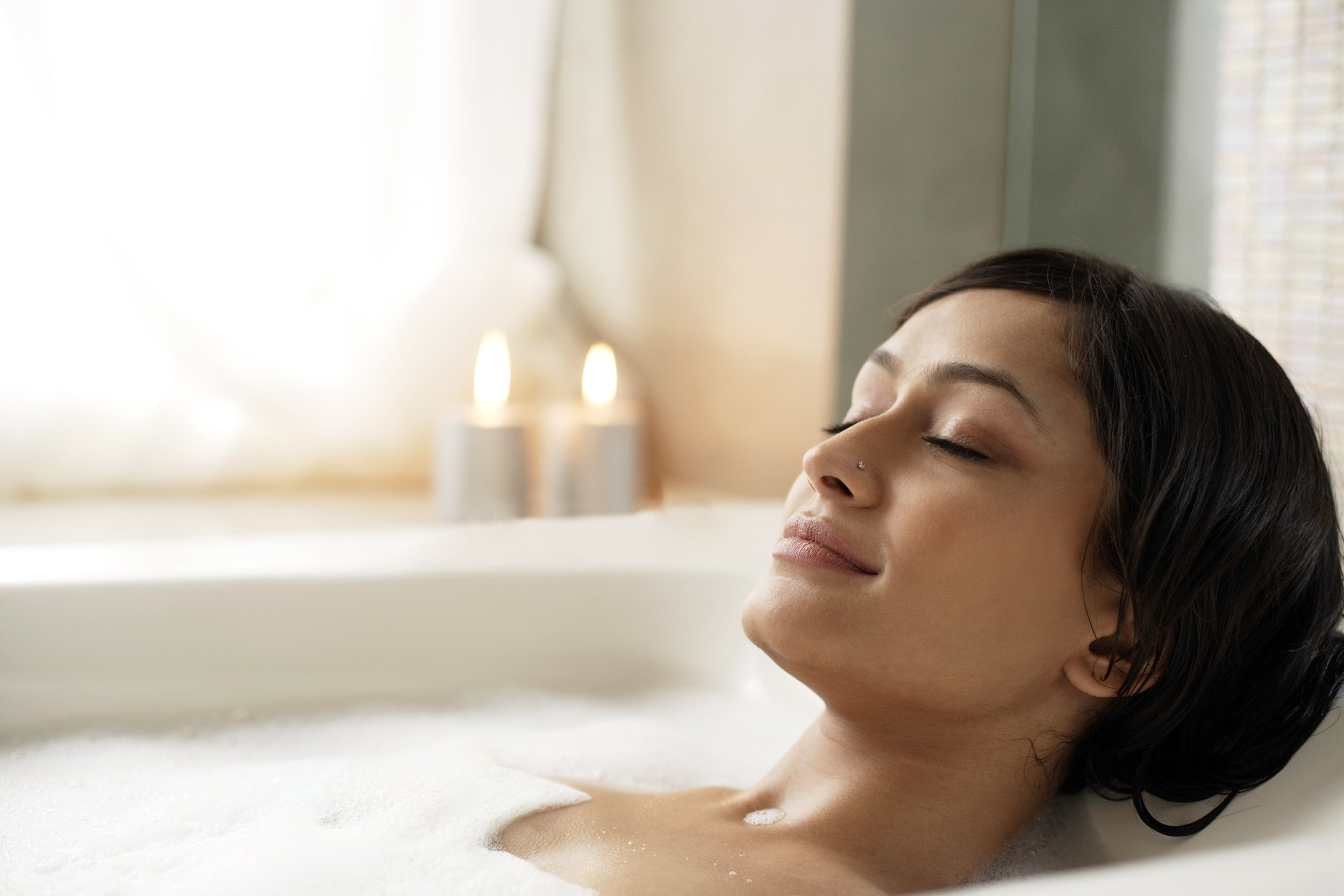 Woman relaxing and taking a hot bath
