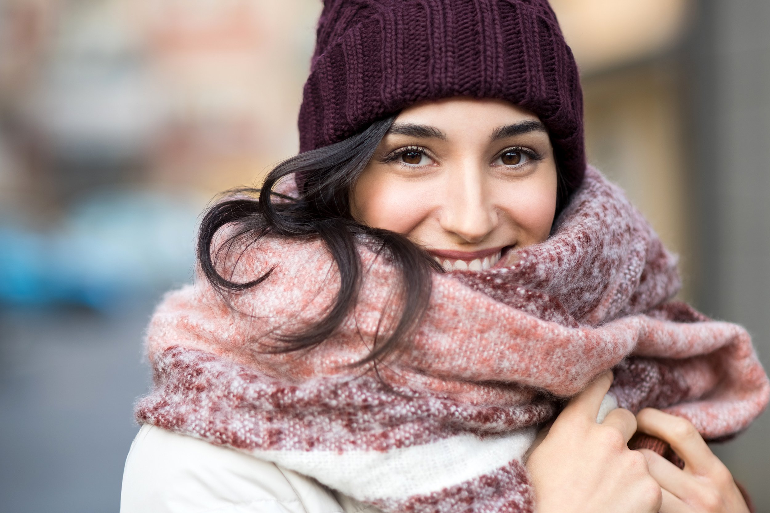 Closeup of woman wearing winter hat and scarf