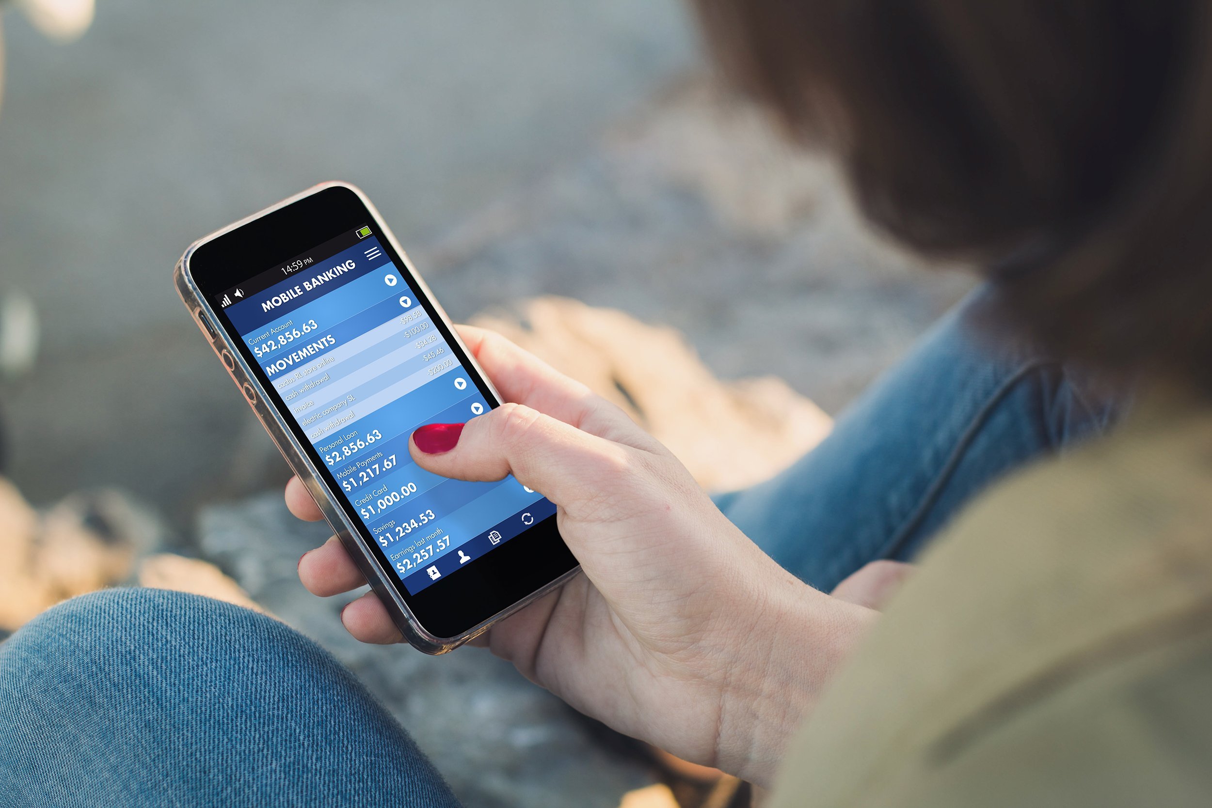 woman holding a smartphone and touching the screen with banking mobile app
